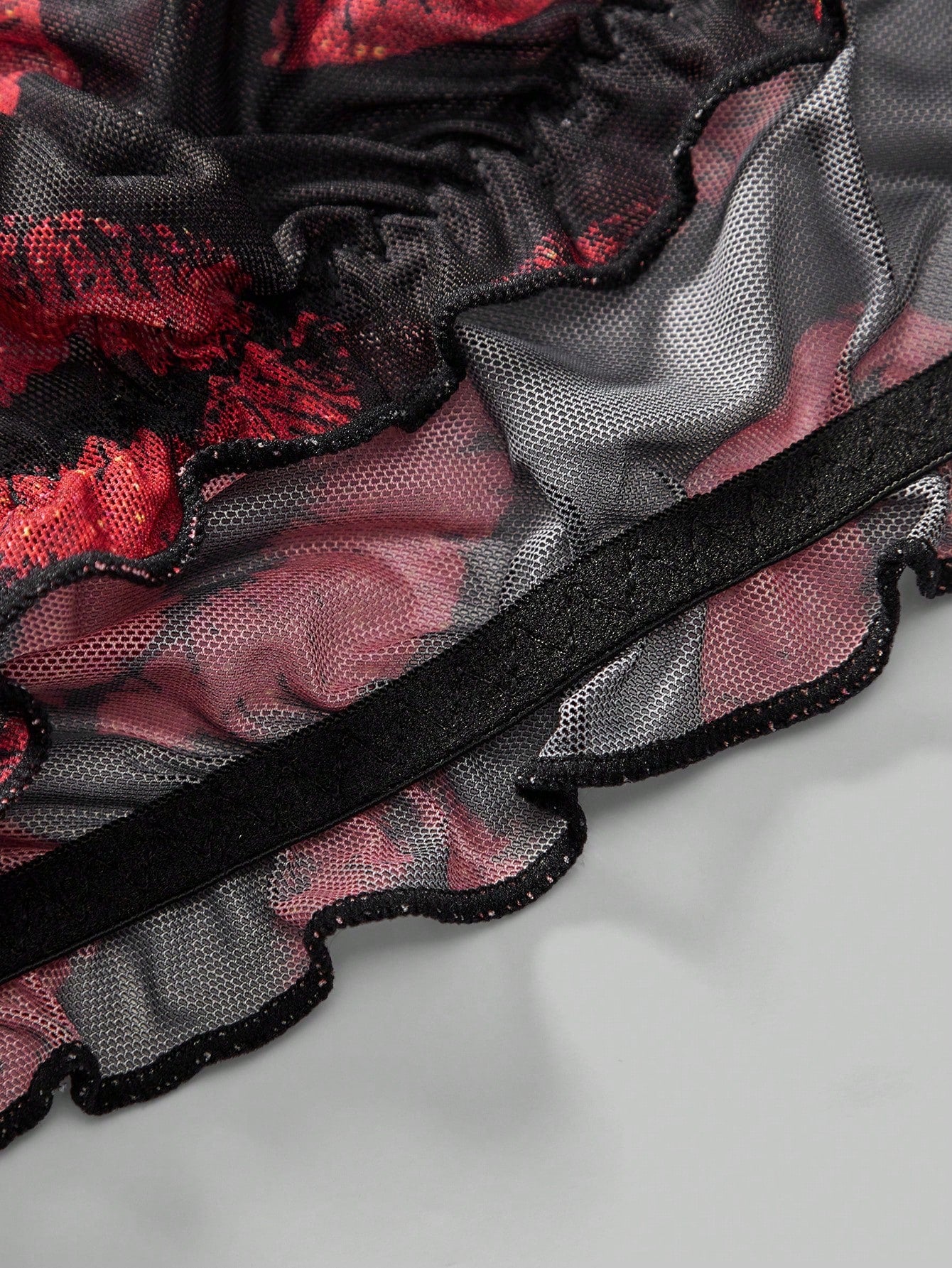 Men's low rise mesh briefs lingerie with random print design, high-stretch fabric, and unlined construction.