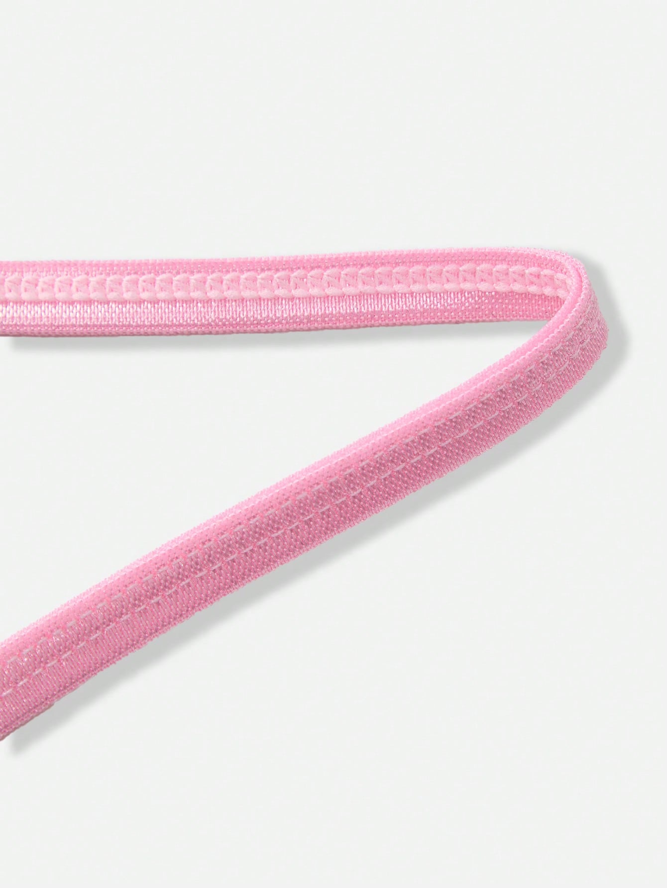 Pink men's lace thong underwear with geometric and floral-inspired print, low-rise waist, unlined design, and medium-stretch fabric.