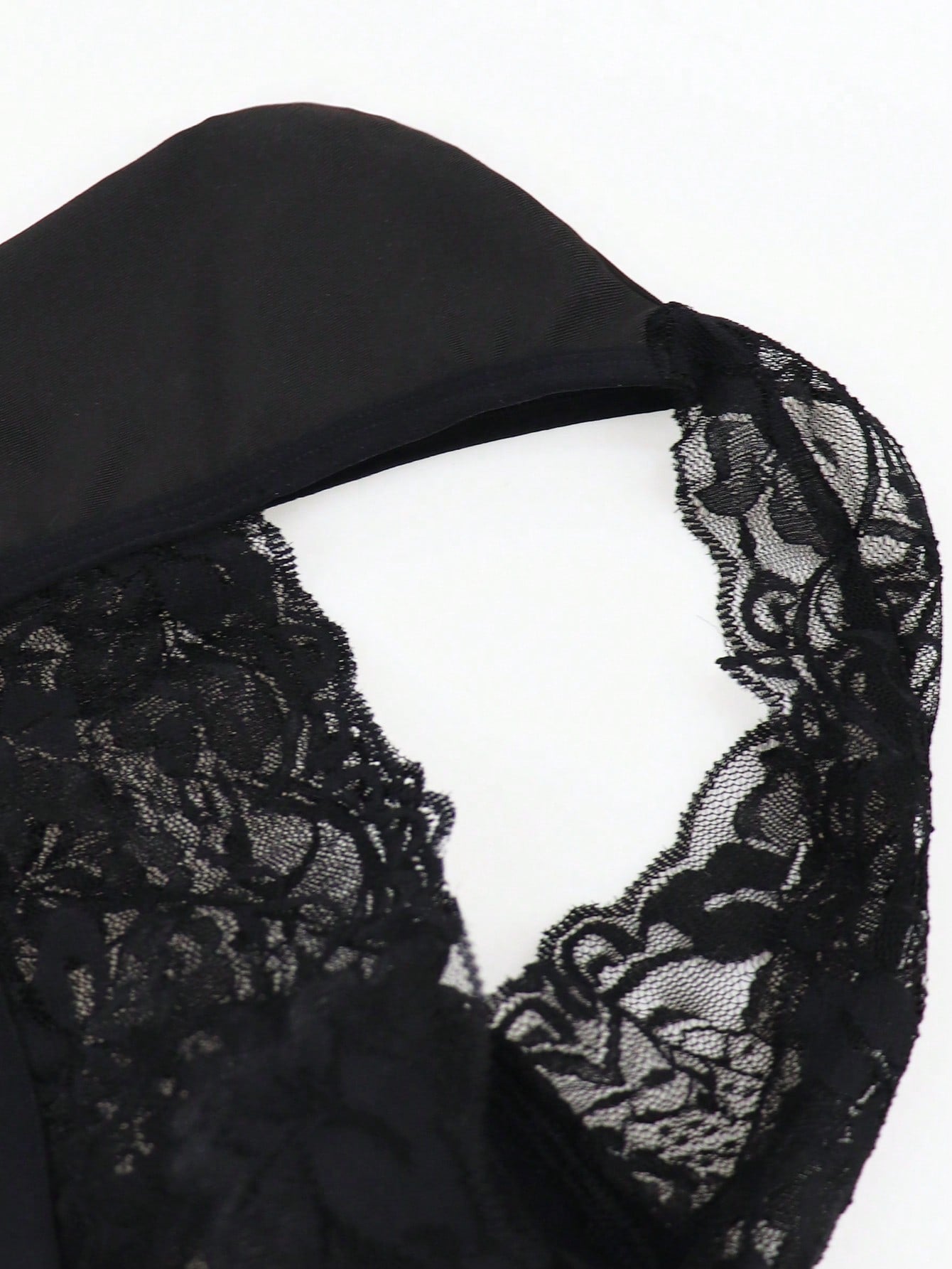 Men's black mid-rise thong briefs in knitted polyamide elastane fabric with medium stretch and plant pattern.