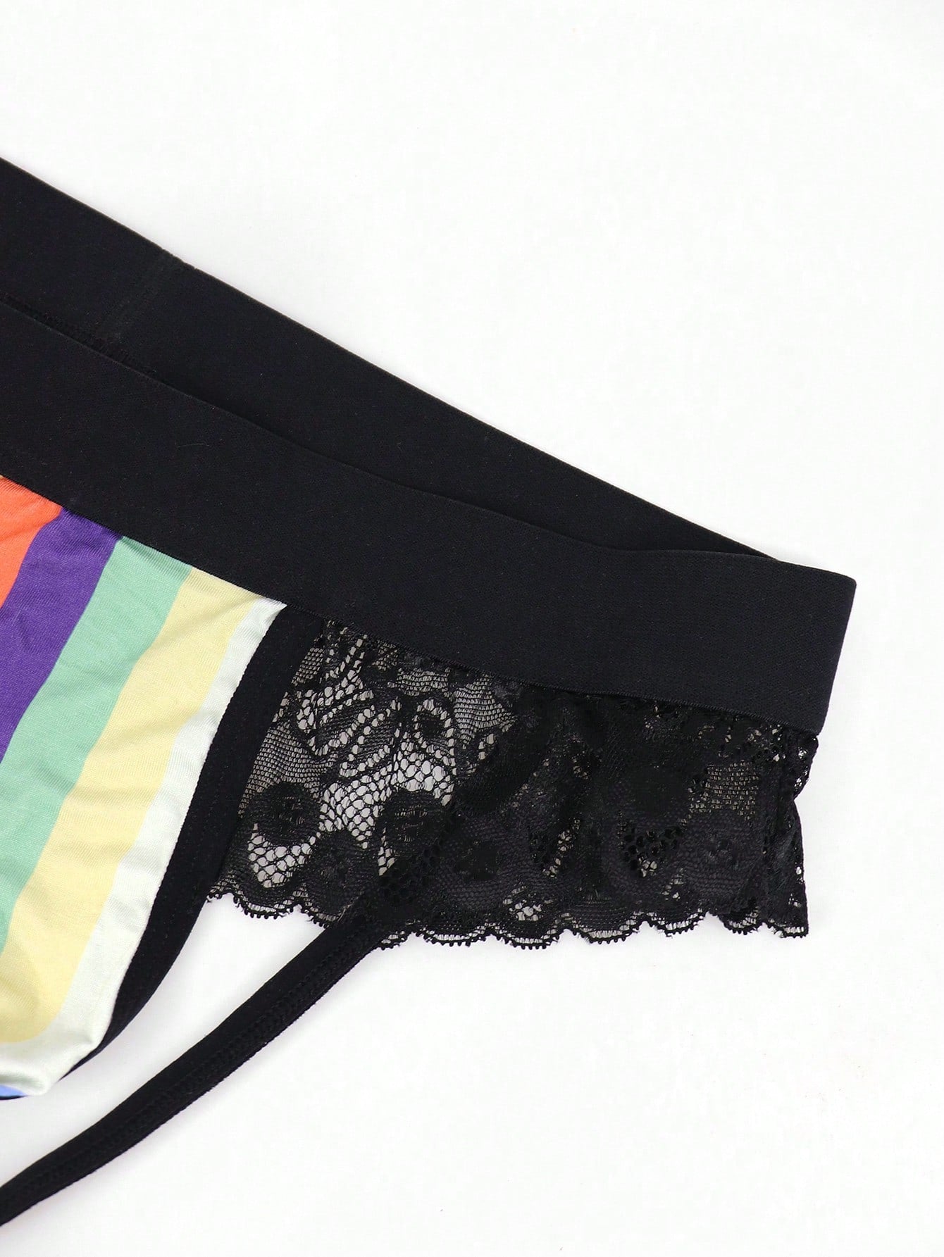 Men's rainbow print jockstrap underwear with graphic letter pattern, low-rise fit, backless design, and knitted polyamide elastane fabric.