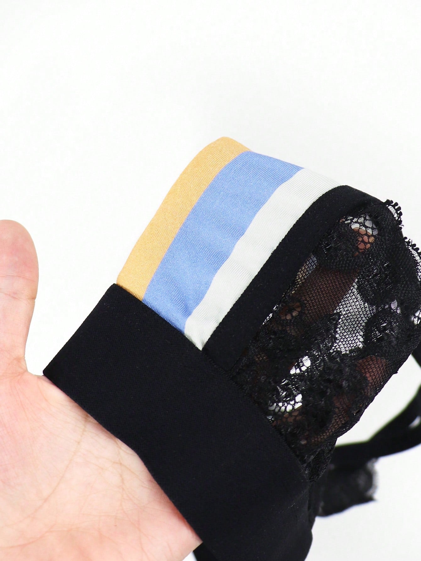 Men's rainbow print jockstrap underwear with graphic letter pattern, low-rise fit, backless design, and knitted polyamide elastane fabric.
