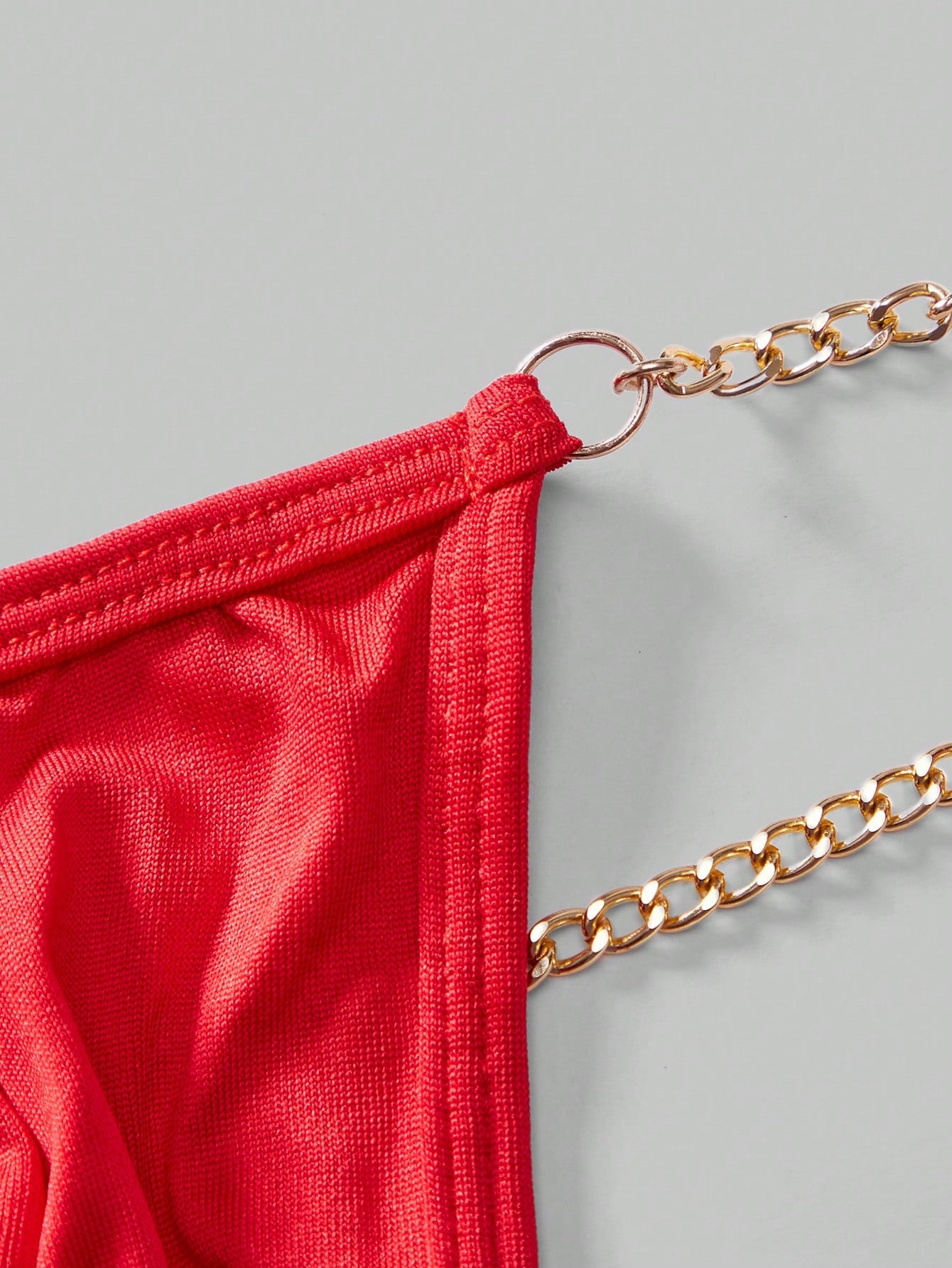 Men's low-rise thong underwear with metal chain detail, colorblock design, and high-stretch knitted fabric in a V-string style.