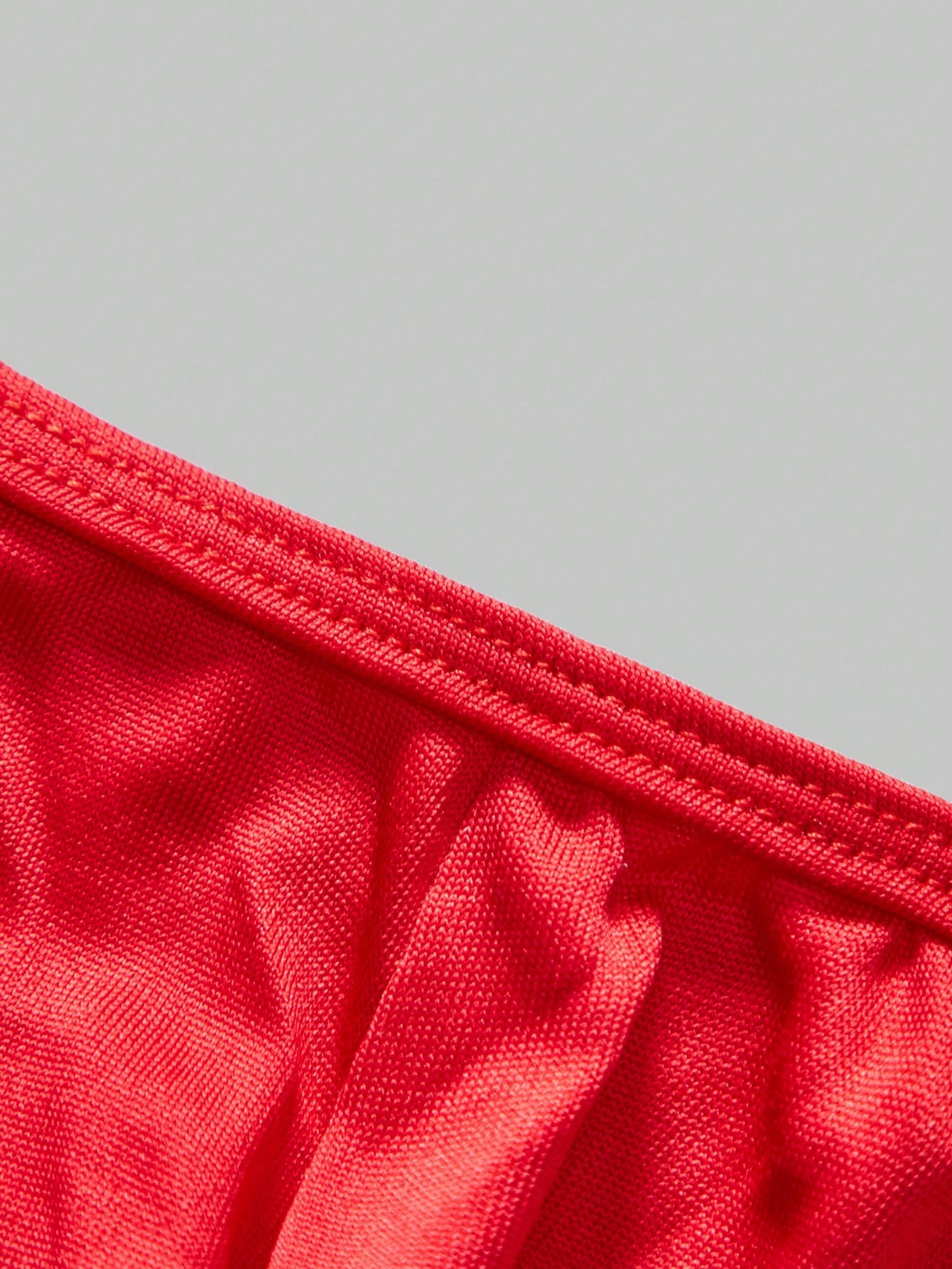 Men's low-rise thong underwear with metal chain detail, colorblock design, and high-stretch knitted fabric in a V-string style.