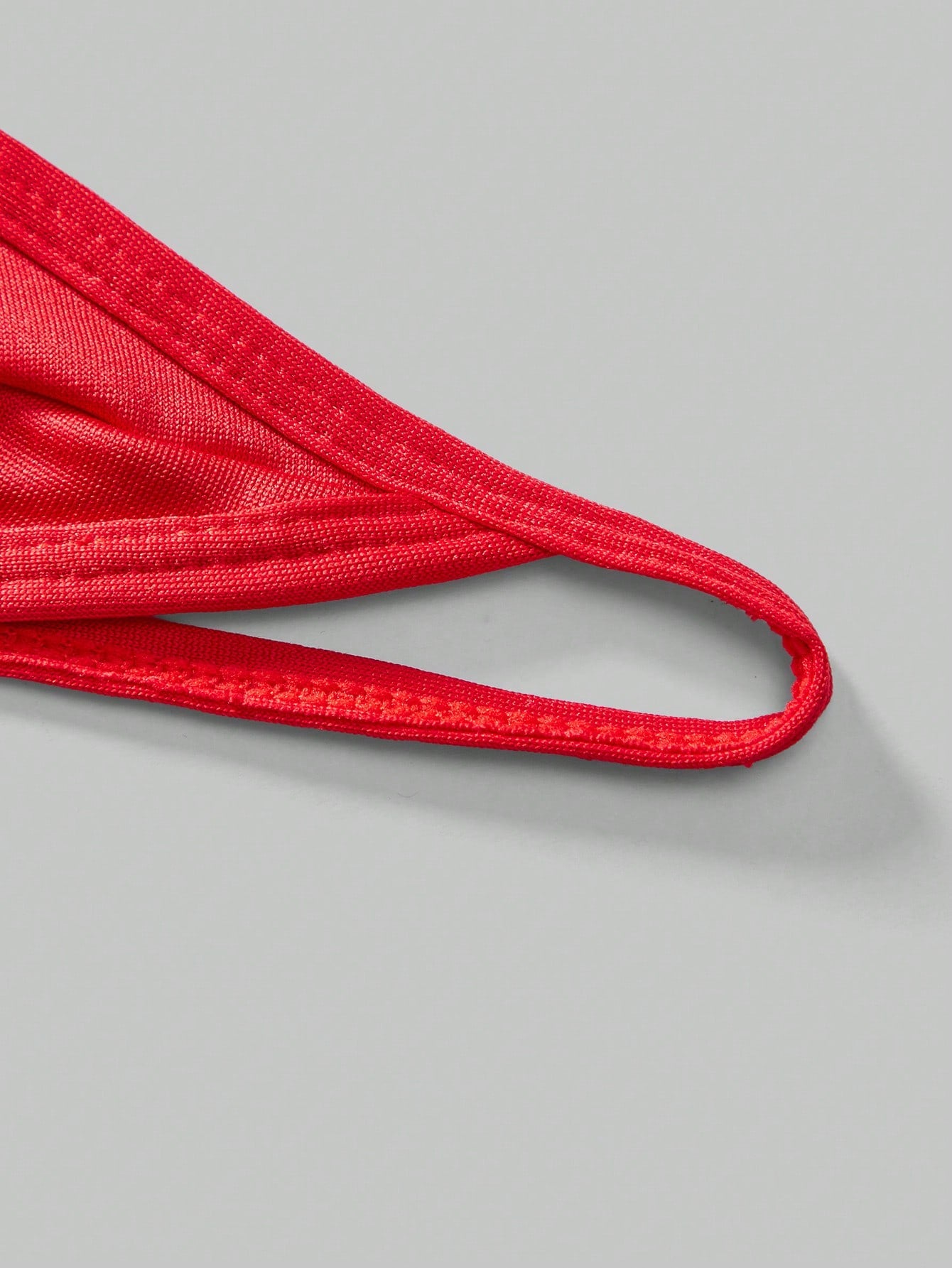 Men's low-rise thong underwear with metal chain detail, colorblock design, and high-stretch knitted fabric in a V-string style.