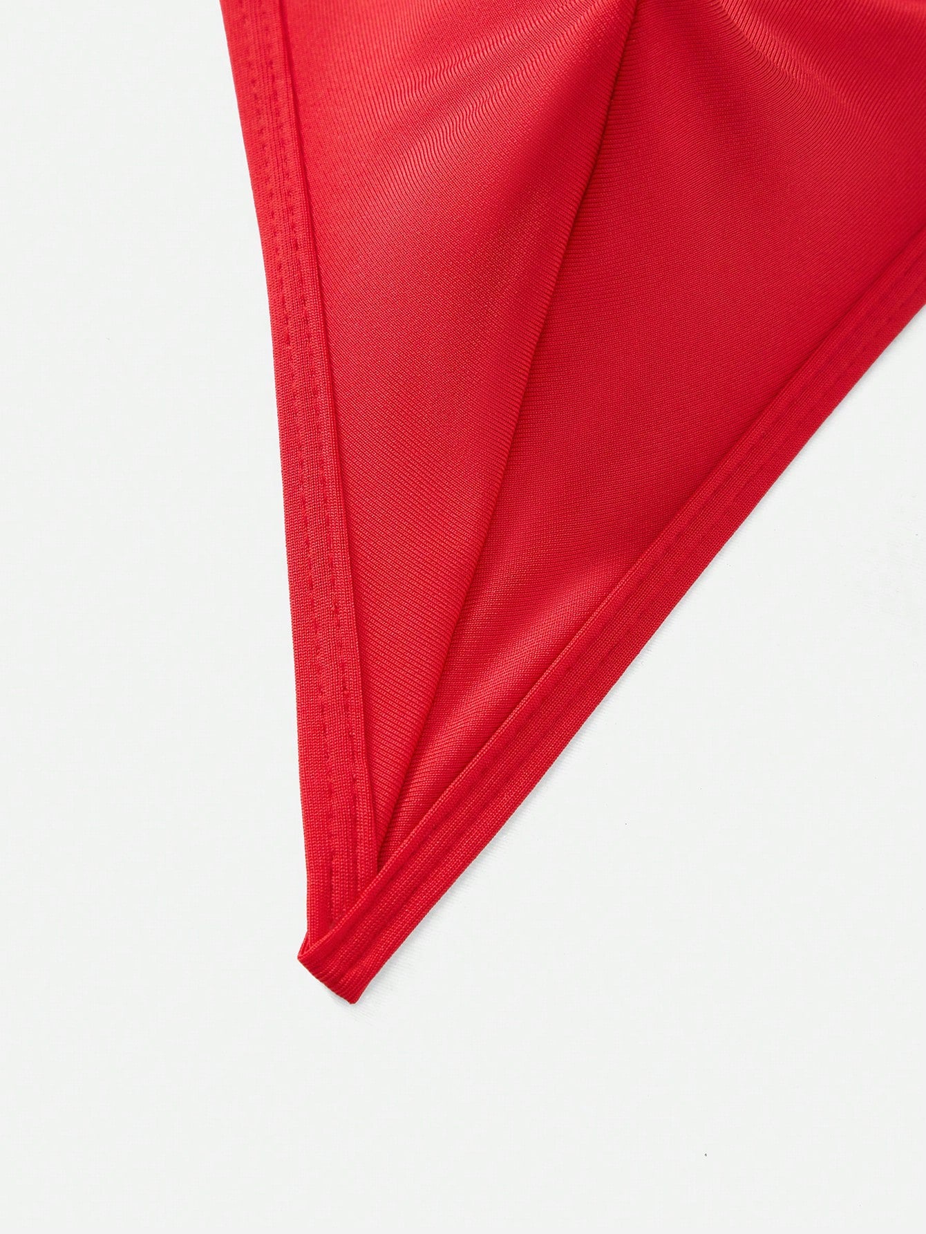 Men's red low rise thong underwear with metal decor, plain design, and high-stretch knitted fabric.