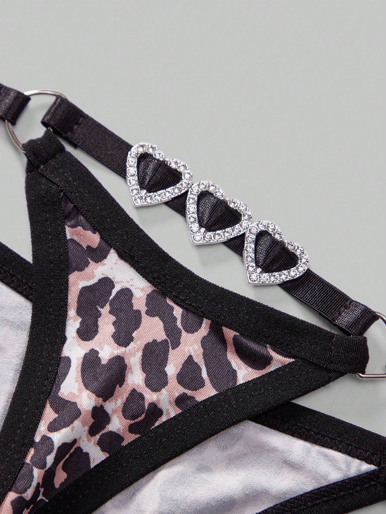 Men's sheer low-rise thong underwear in knitted fabric with rhinestone heart decor, ring detail, and medium-stretch fit.