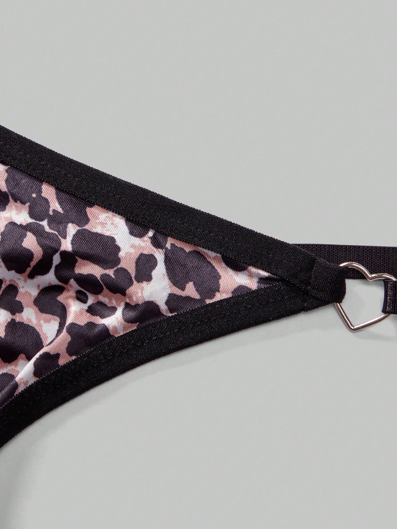 Men's sheer low-rise thong underwear in knitted fabric with rhinestone heart decor, ring detail, and medium-stretch fit.