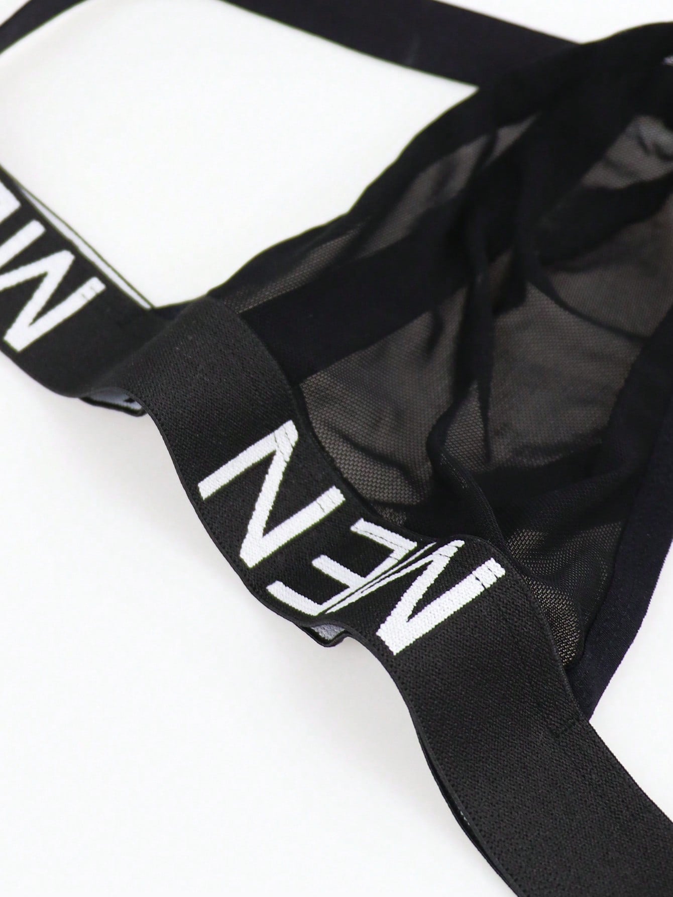 Men's low rise mesh jockstrap underwear with letter pattern, medium stretch fabric, made from 92% polyamide and 8% elastane.