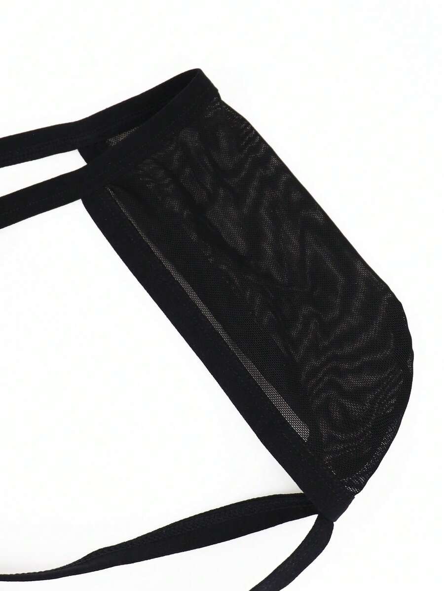 Men's black mesh jockstrap underwear featuring sheer hollow design and low rise fit.