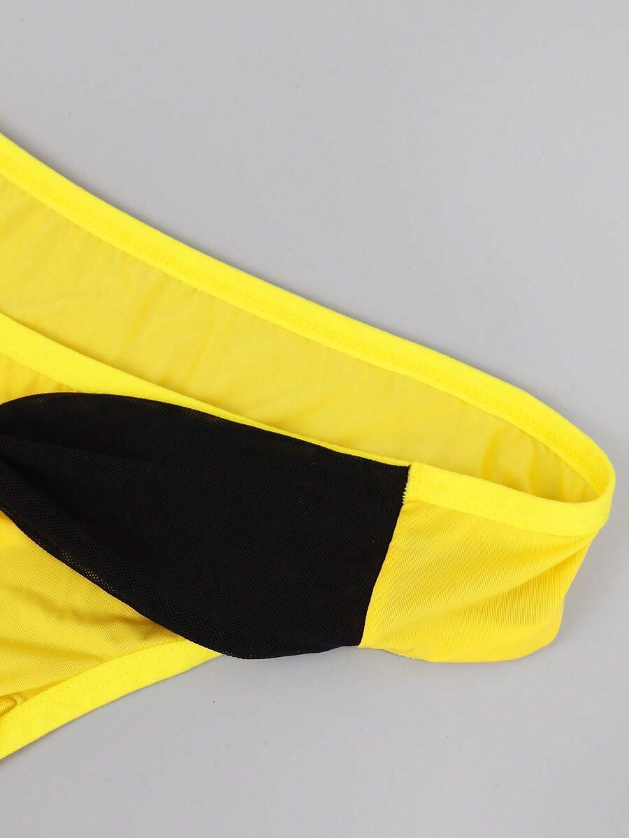 Men's multicolor mid-rise thong underwear featuring contrast mesh details and a colorblock pattern.