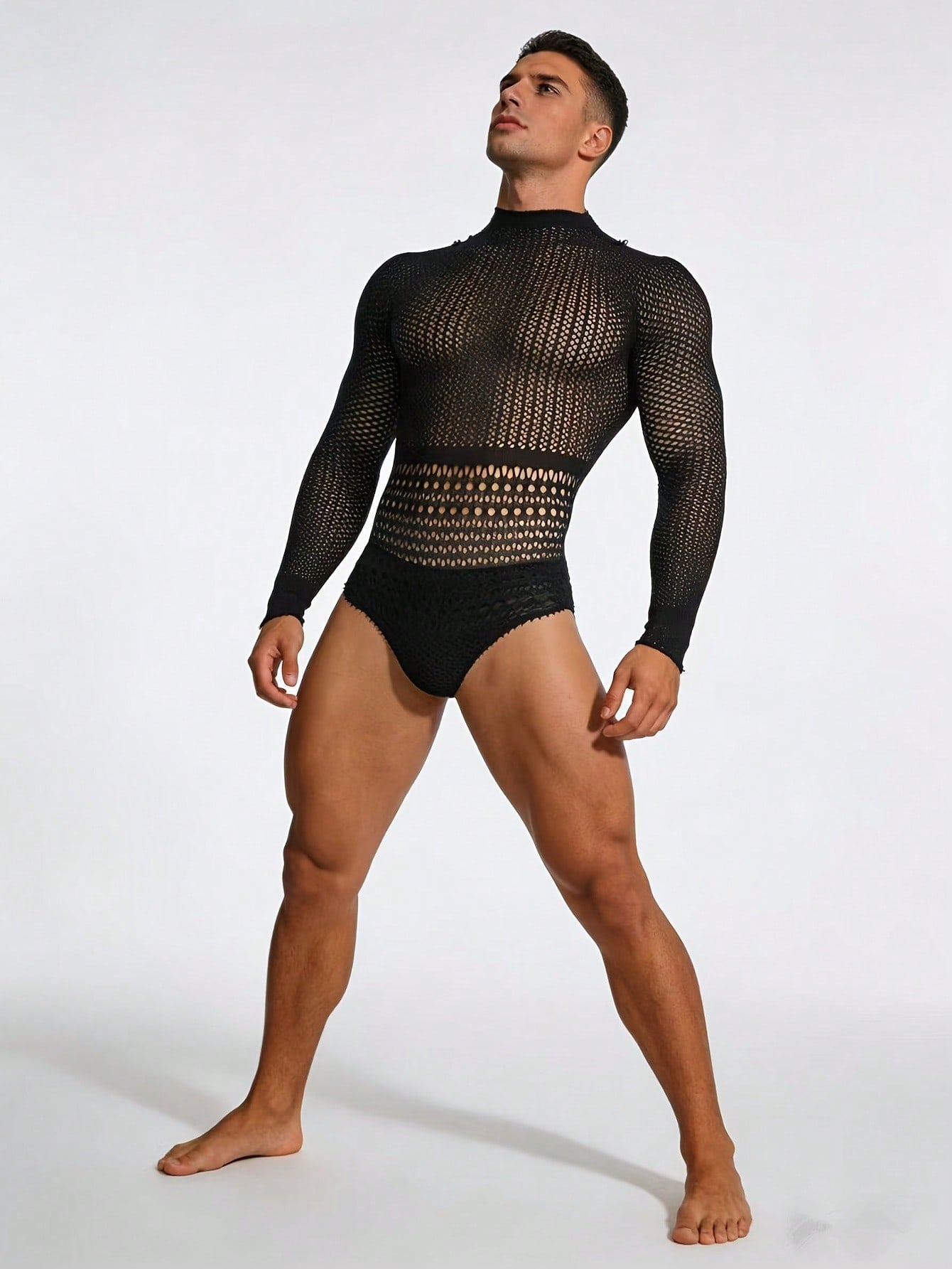 Black fishnet jumpsuit lingerie for men with hollow out detail, sheer knitted fabric, stand collar, high rise fit, and high stretch polyamide construction.