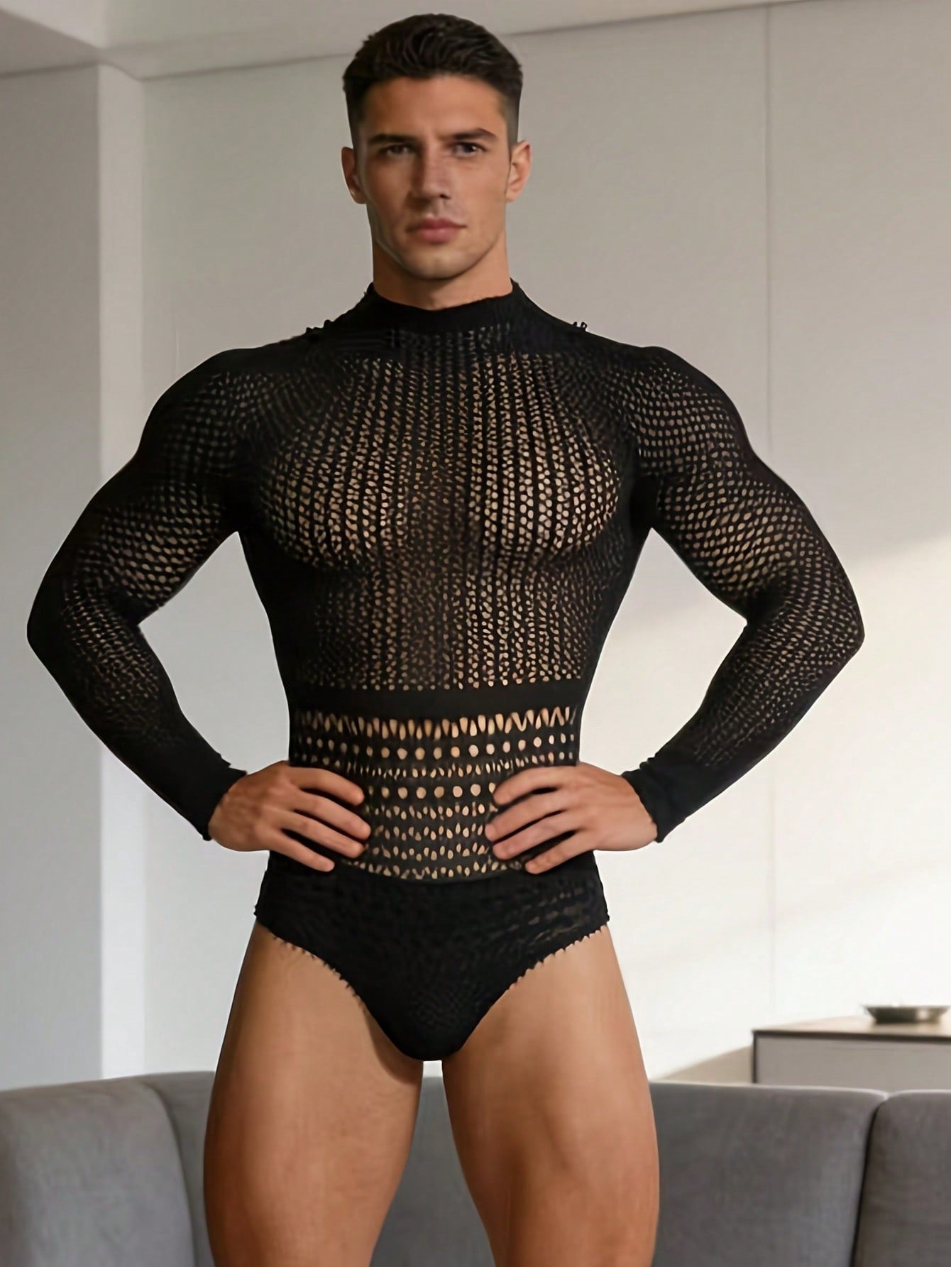 Black fishnet jumpsuit lingerie for men with hollow out detail, sheer knitted fabric, stand collar, high rise fit, and high stretch polyamide construction.
