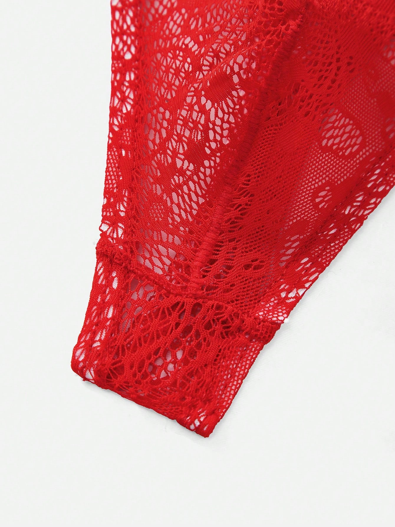Red lace semi-sheer thong panty with hollow out detail and low rise design, made from stretchy polyamide and elastane blend.