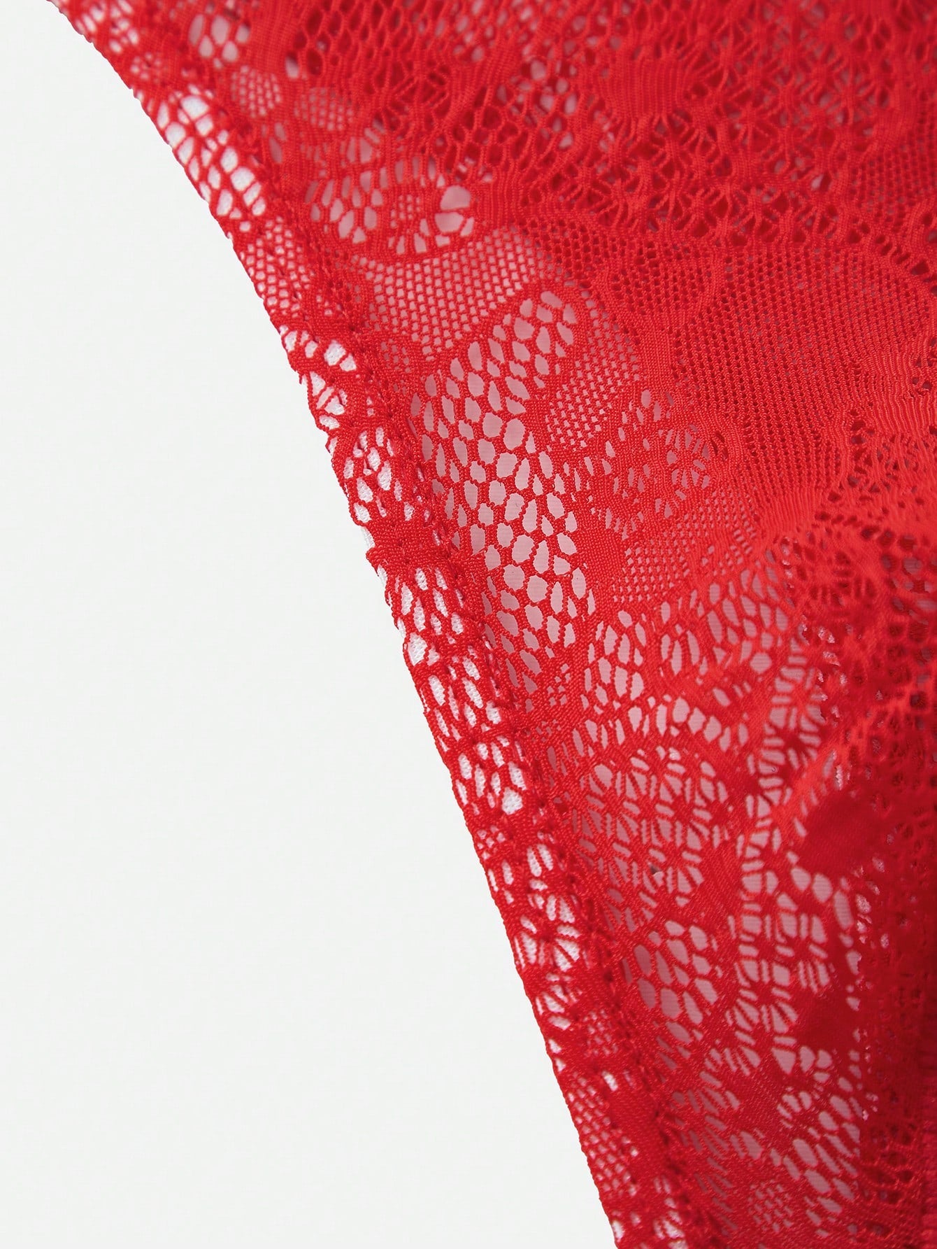 Red lace semi-sheer thong panty with hollow out detail and low rise design, made from stretchy polyamide and elastane blend.