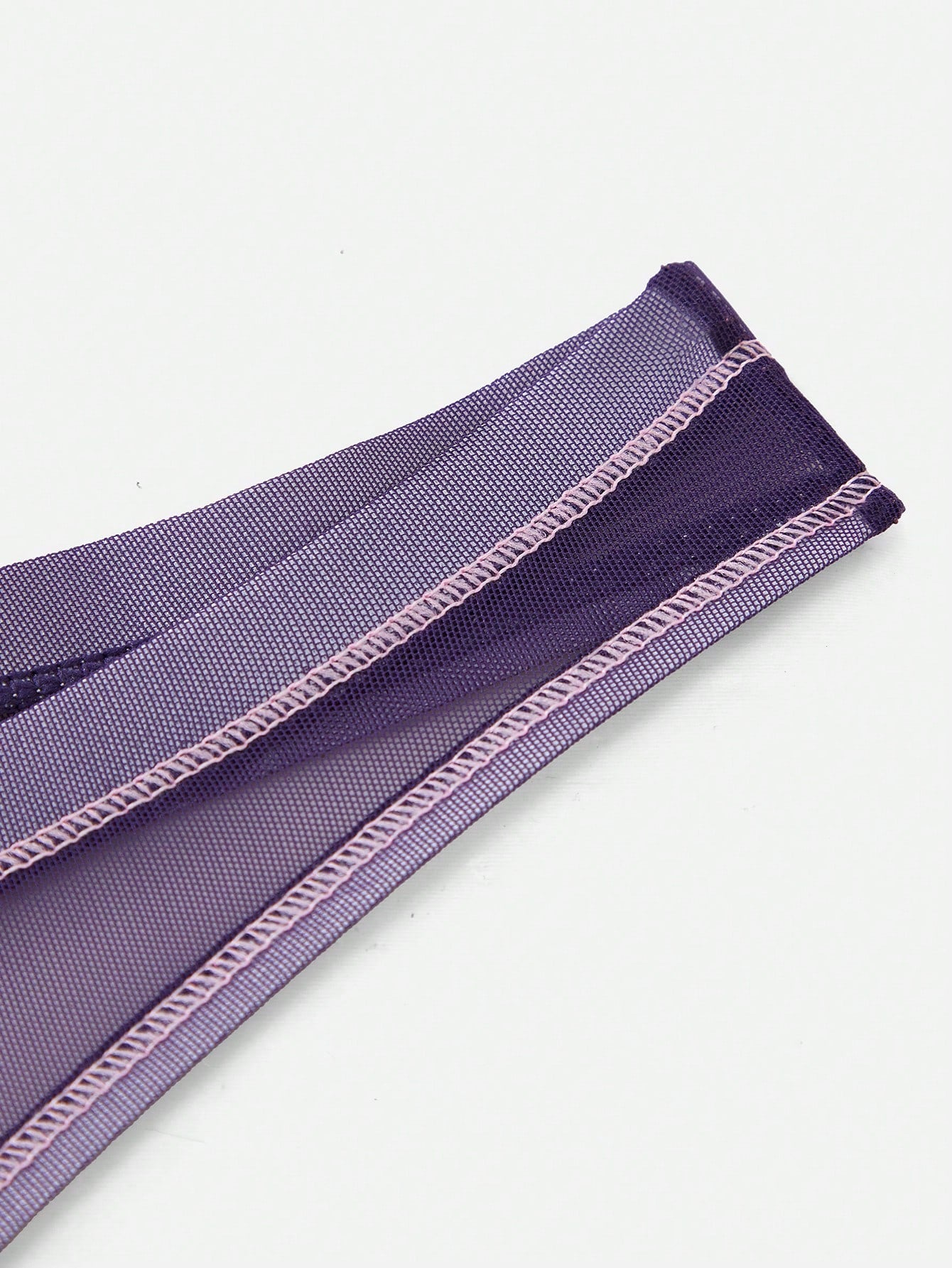 Men's purple semi-sheer mesh thong underwear with low-rise fit, colorblock design, and high-stretch fabric.