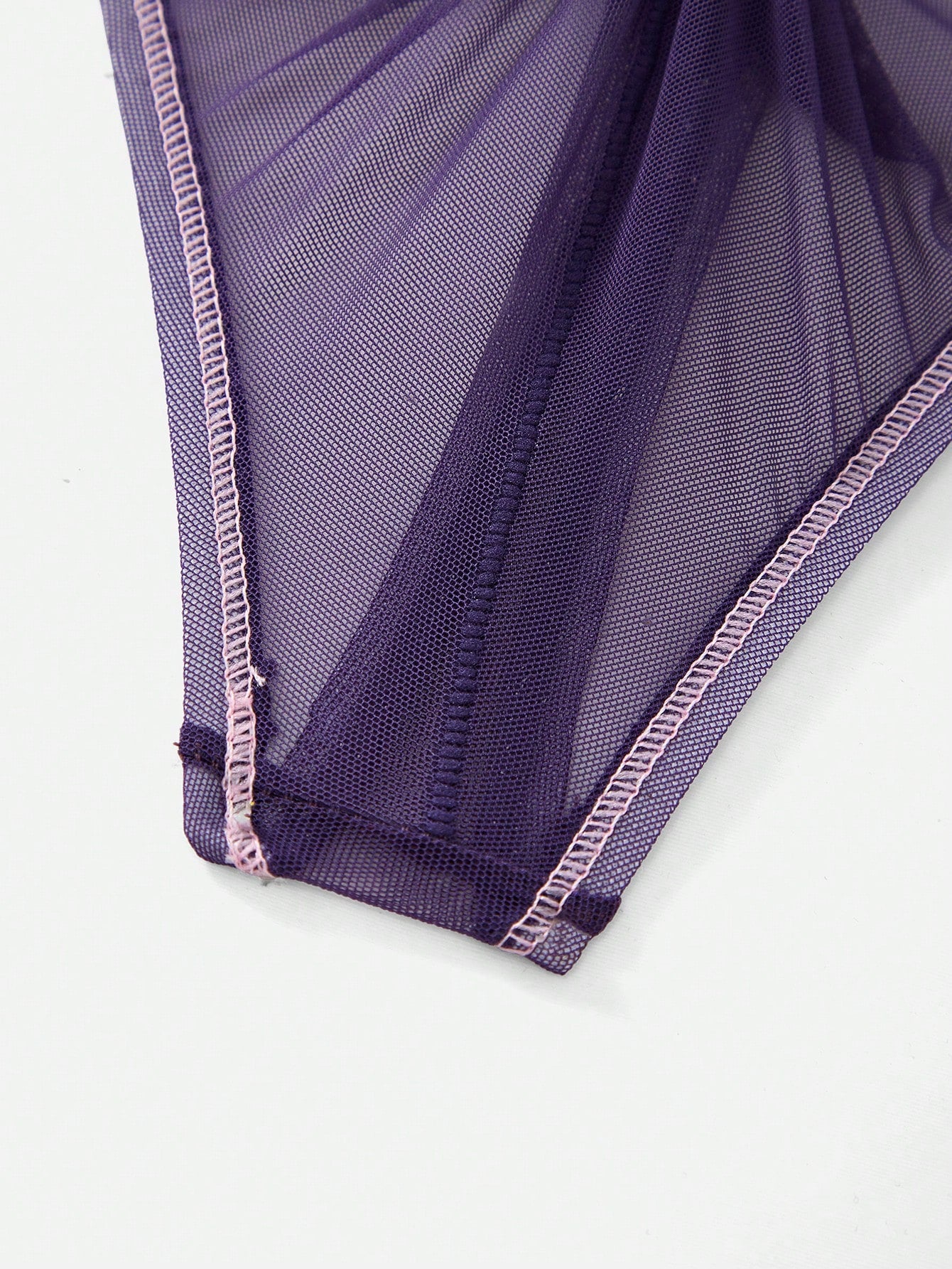 Men's purple semi-sheer mesh thong underwear with low-rise fit, colorblock design, and high-stretch fabric.