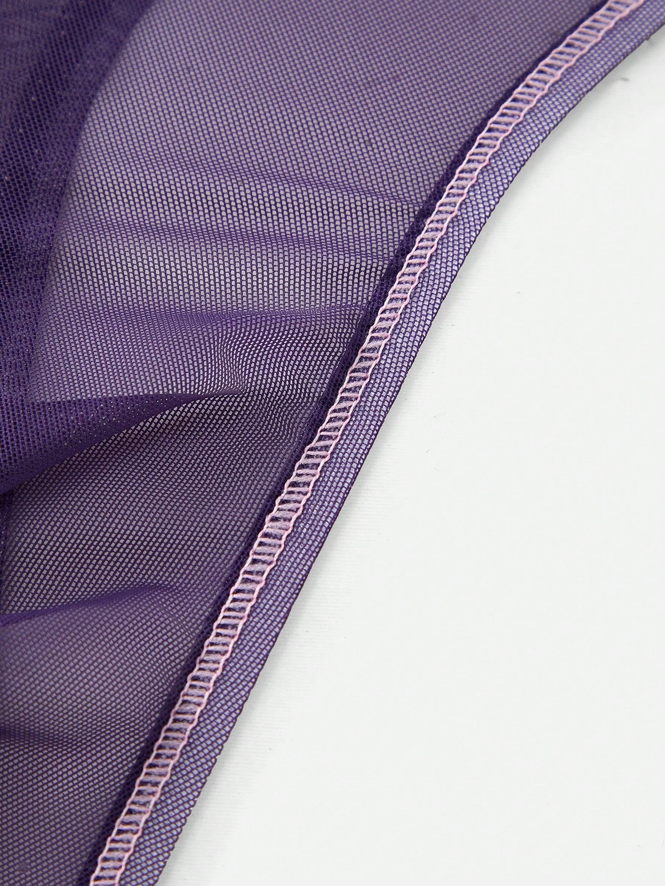 Men's purple semi-sheer mesh thong underwear with low-rise fit, colorblock design, and high-stretch fabric.