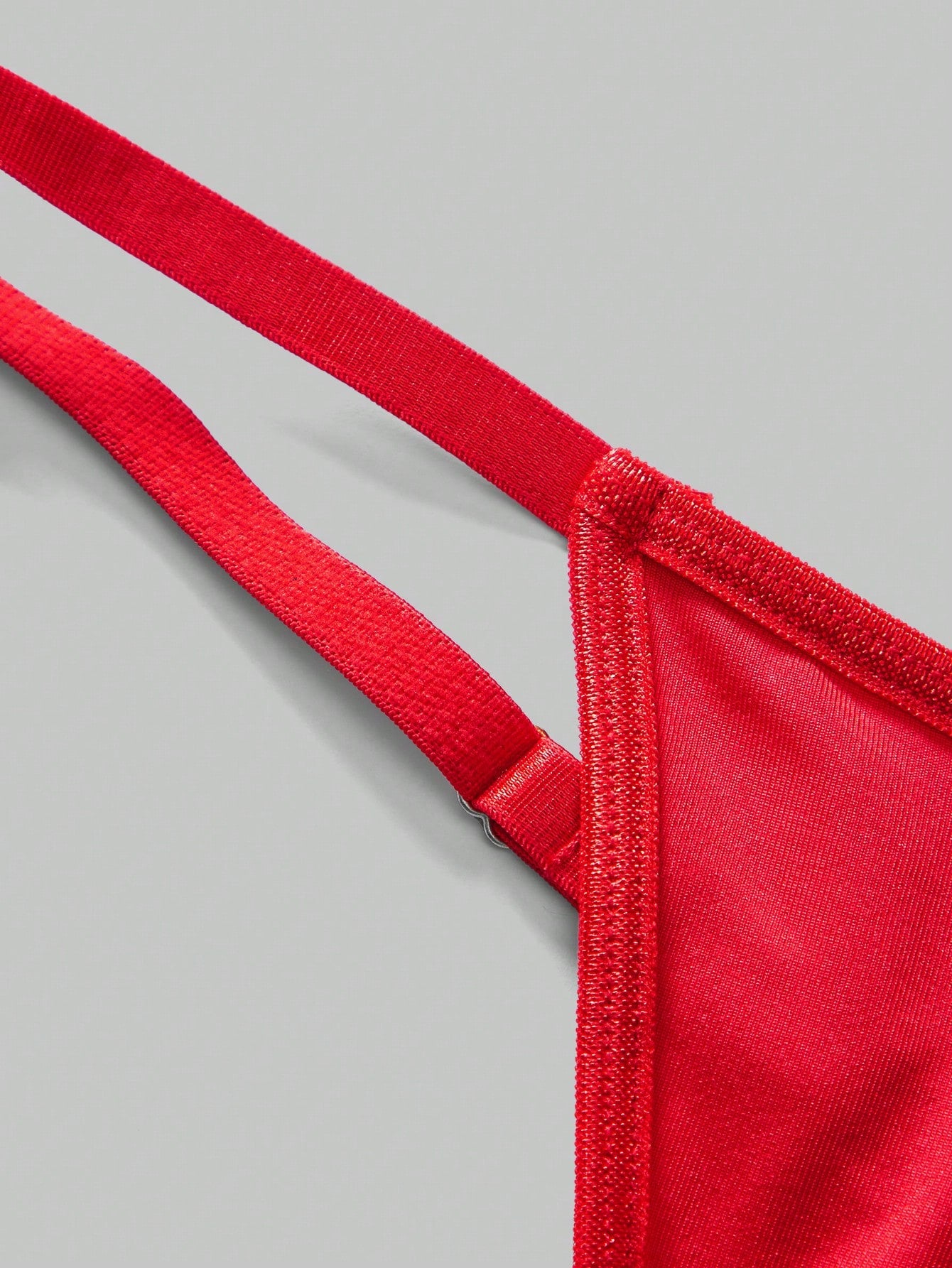 Men's red low rise thong briefs with chain decor, plain knitted fabric, high stretch polyester spandex blend, unlined and non-sheer.