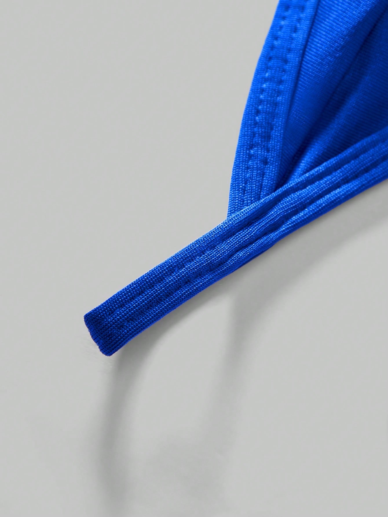 Men's low-rise thong underwear with metal chain detail, colorblock design, and high-stretch knitted fabric in a V-string style.