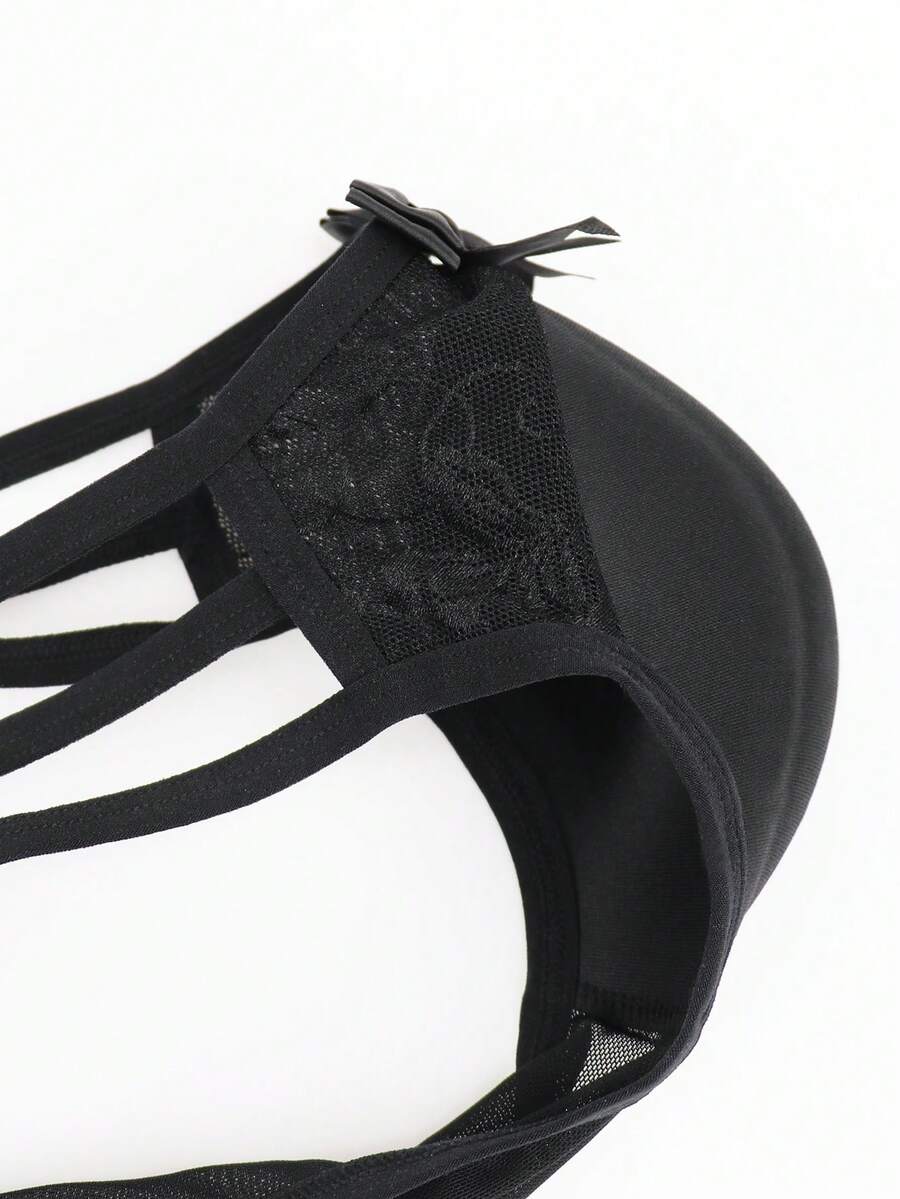 Men's black low-rise hollow mesh briefs featuring a zipper detail and striped pattern.
