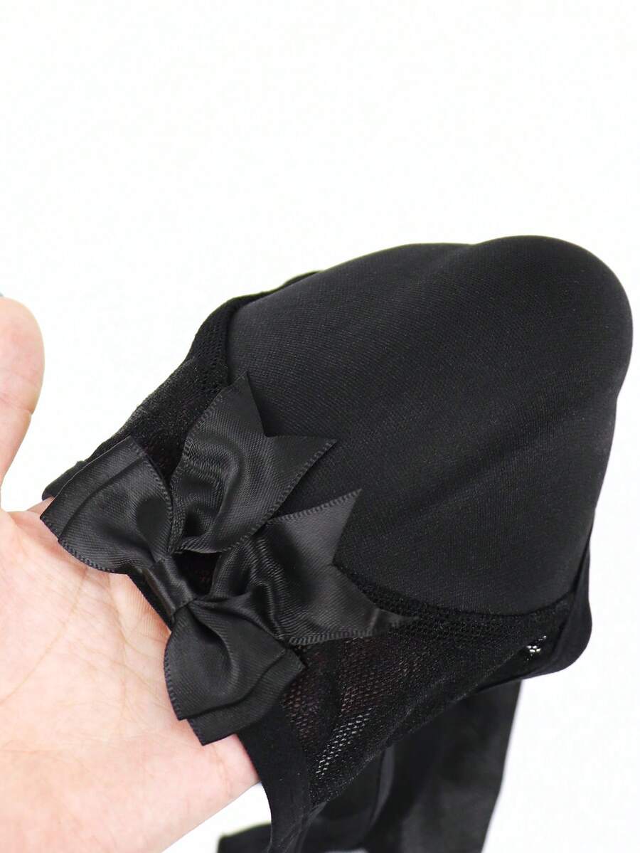 Men's black low-rise hollow mesh briefs featuring a zipper detail and striped pattern.