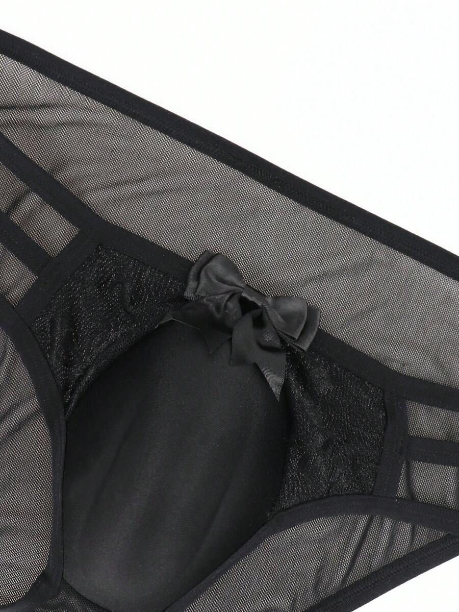 Men's black low-rise hollow mesh briefs featuring a zipper detail and striped pattern.