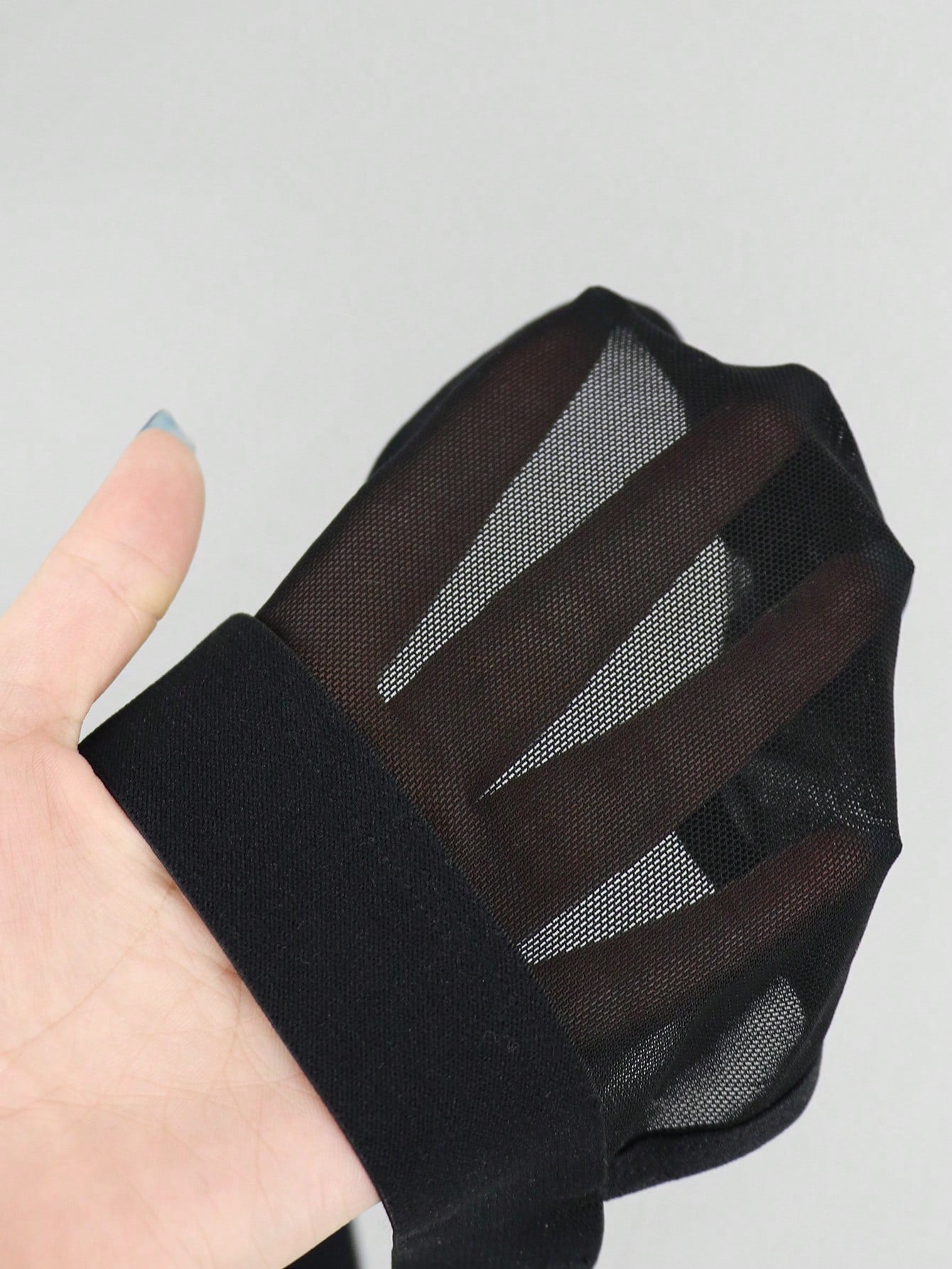 Black men's low rise jockstrap underwear in mesh fabric with colorblock design, medium stretch, and backless crotchless styling.