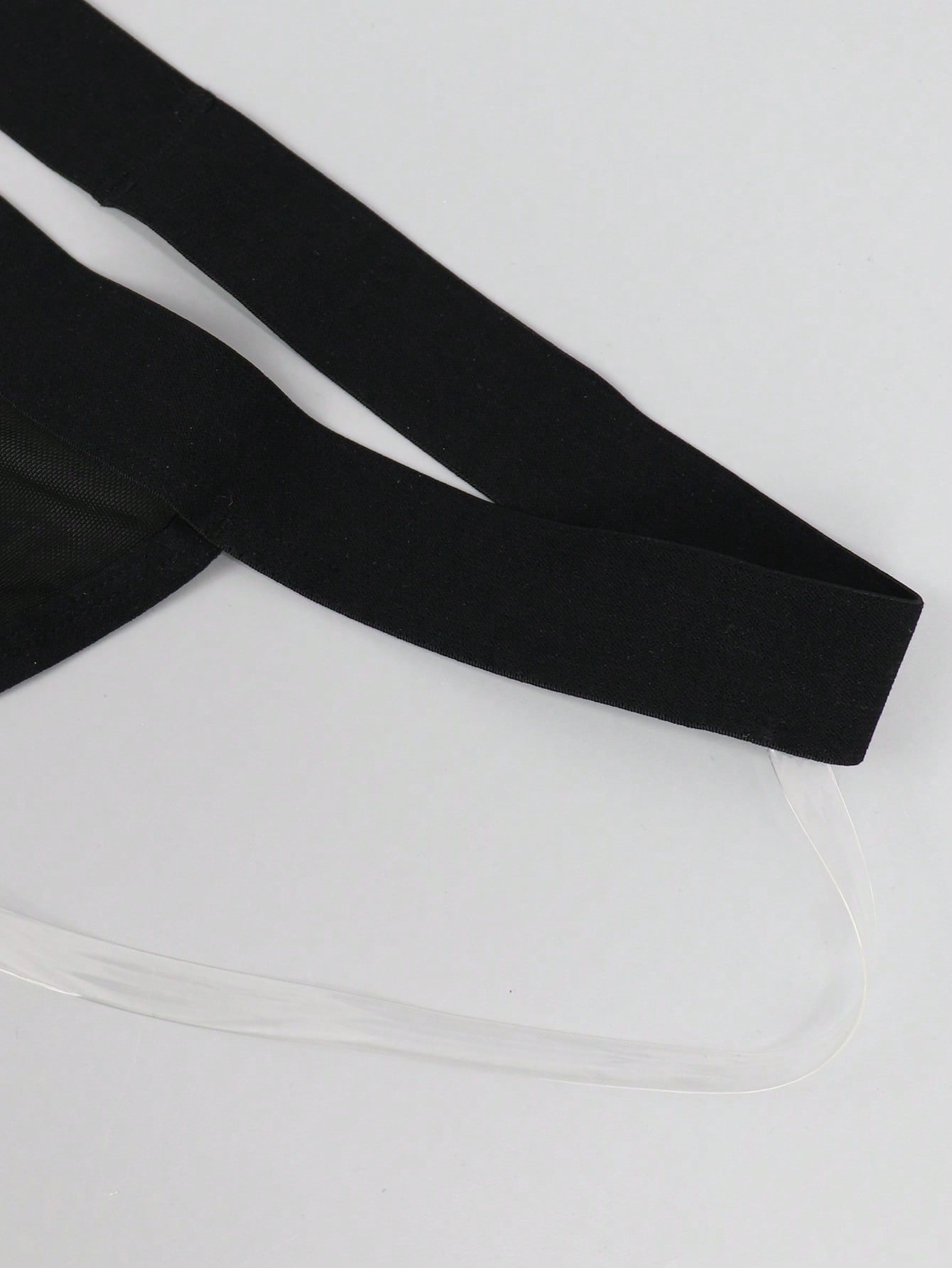 Black men's low rise jockstrap underwear in mesh fabric with colorblock design, medium stretch, and backless crotchless styling.