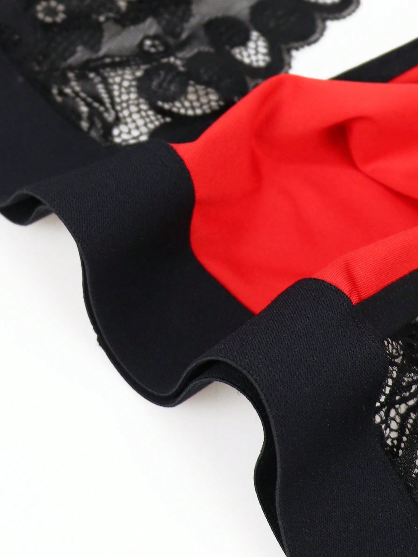 Men's low rise jockstrap underwear with red colorblock design, lace waist, and contrast binding in medium-stretch knitted fabric.