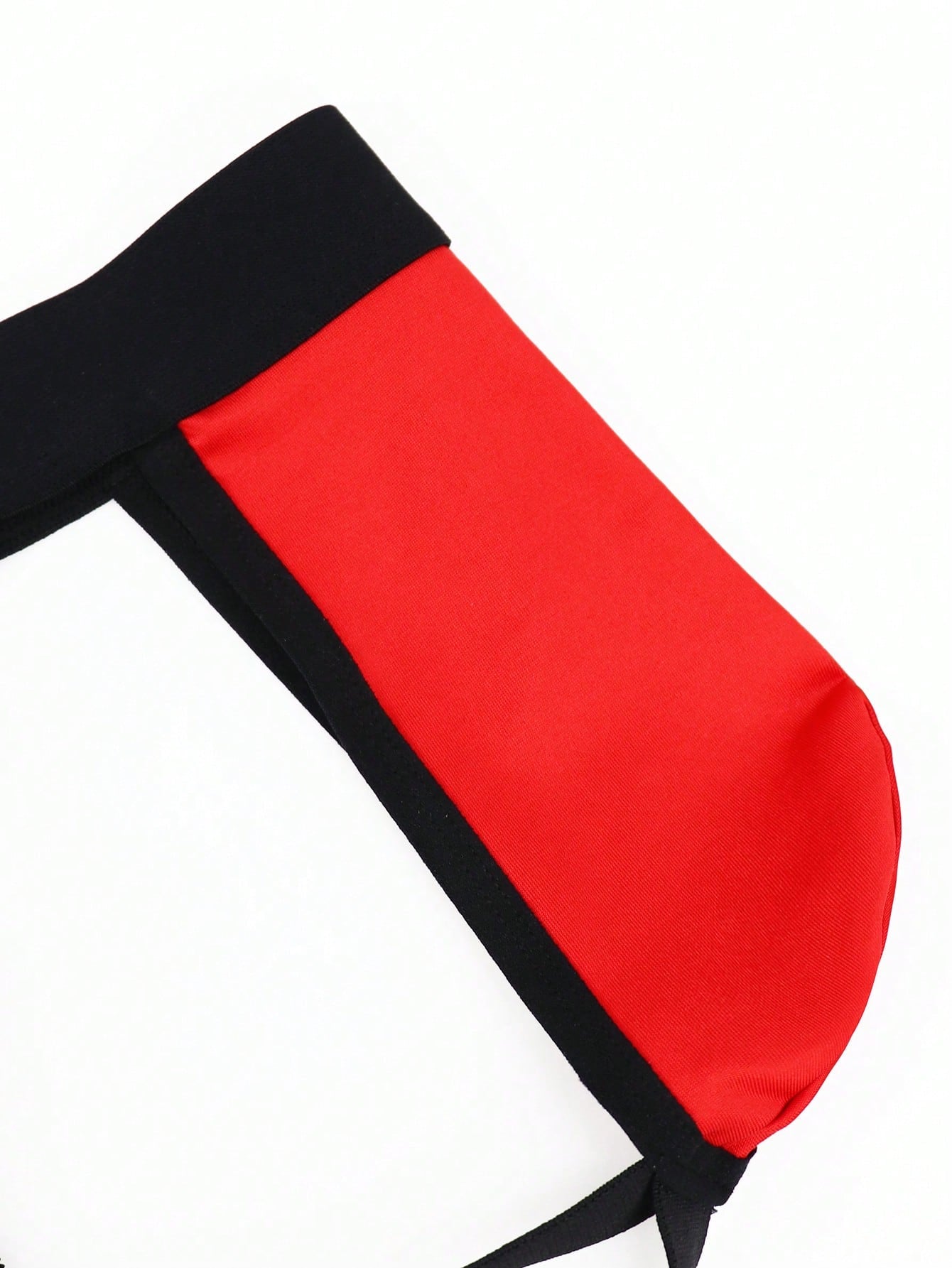 Men's low rise jockstrap underwear with red colorblock design, lace waist, and contrast binding in medium-stretch knitted fabric.