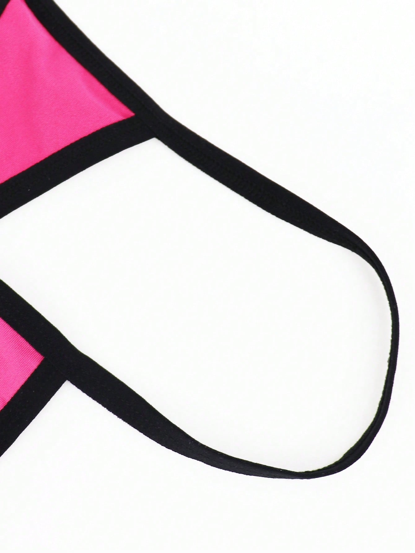 Hot pink men's thong underwear in knitted fabric with contrast binding, colorblock design, and mid-rise fit.