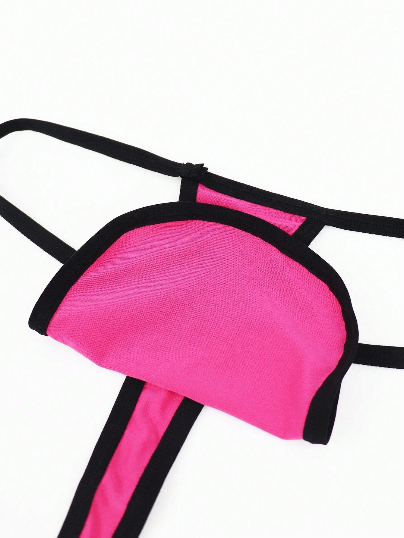 Hot pink men's thong underwear in knitted fabric with contrast binding, colorblock design, and mid-rise fit.