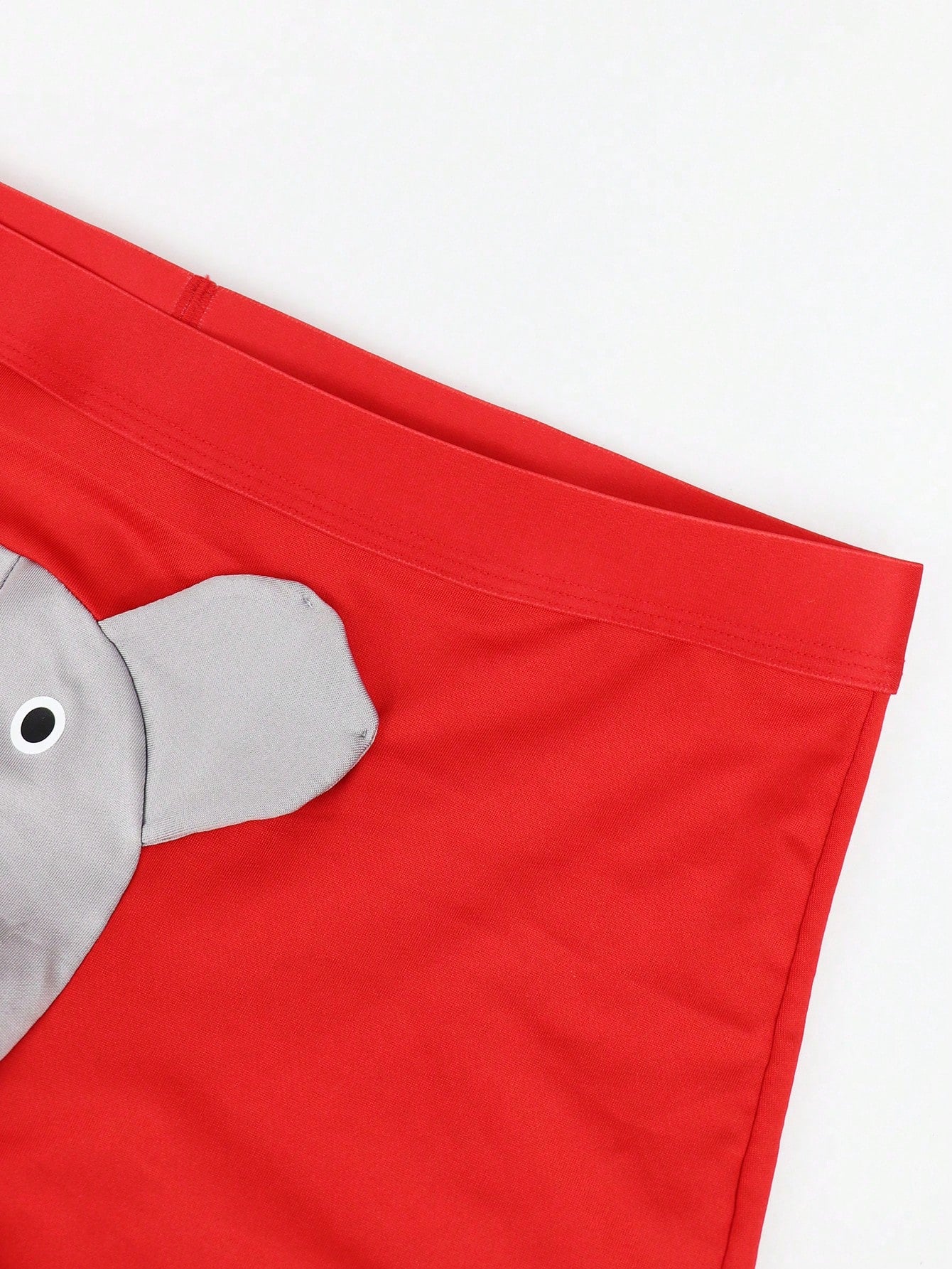 Men's mid-rise boxer shorts in red knitted fabric with medium stretch, featuring animal and cartoon pattern details.