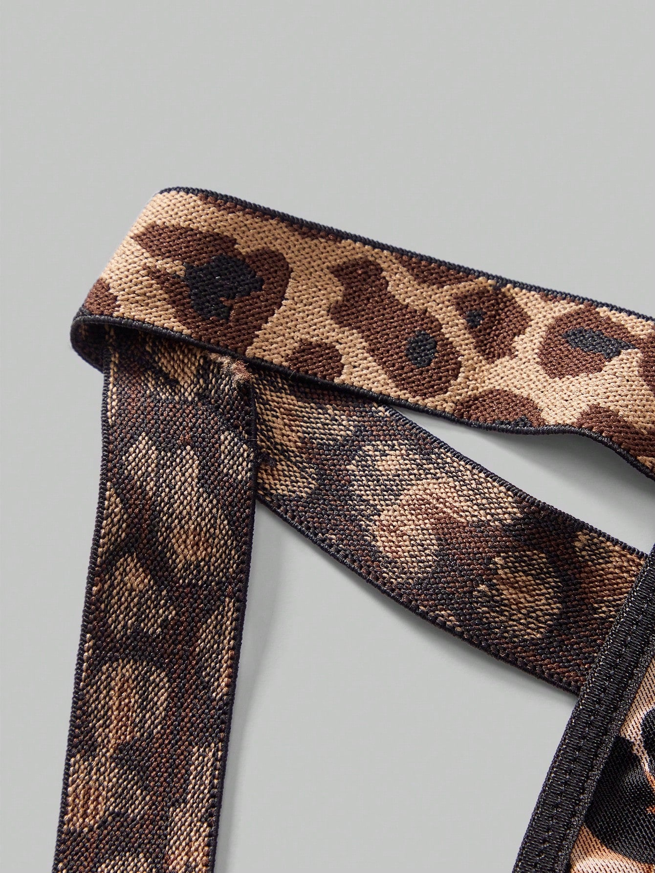 Men's sexy lingerie 3-piece set in leopard print mesh with matching leopard print straps, short vest top, and low rise thong styling for rave, festival, or Halloween wear.