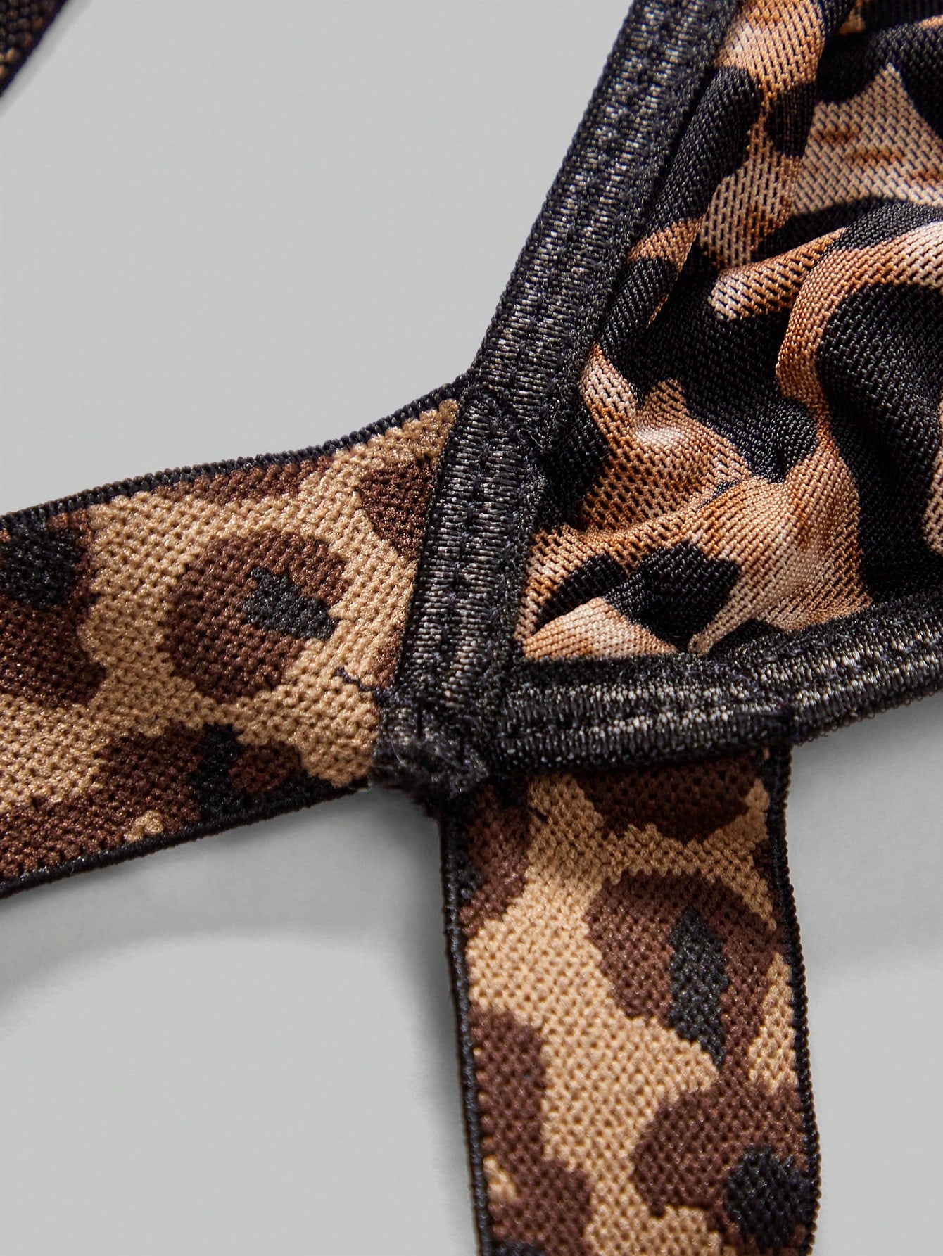 Men's sexy lingerie 3-piece set in leopard print mesh with matching leopard print straps, short vest top, and low rise thong styling for rave, festival, or Halloween wear.