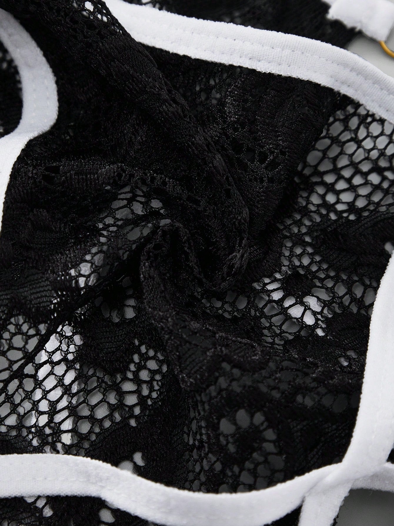 Men's black semi-sheer lace thong underwear with low rise fit, plain pattern, slight stretch fabric, and bowknot ribbon detail.