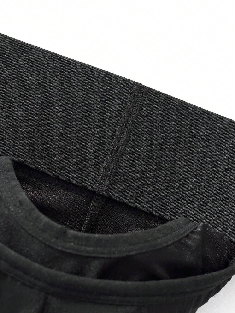 Black low rise men's jockstrap underwear featuring a letter print wide waistband