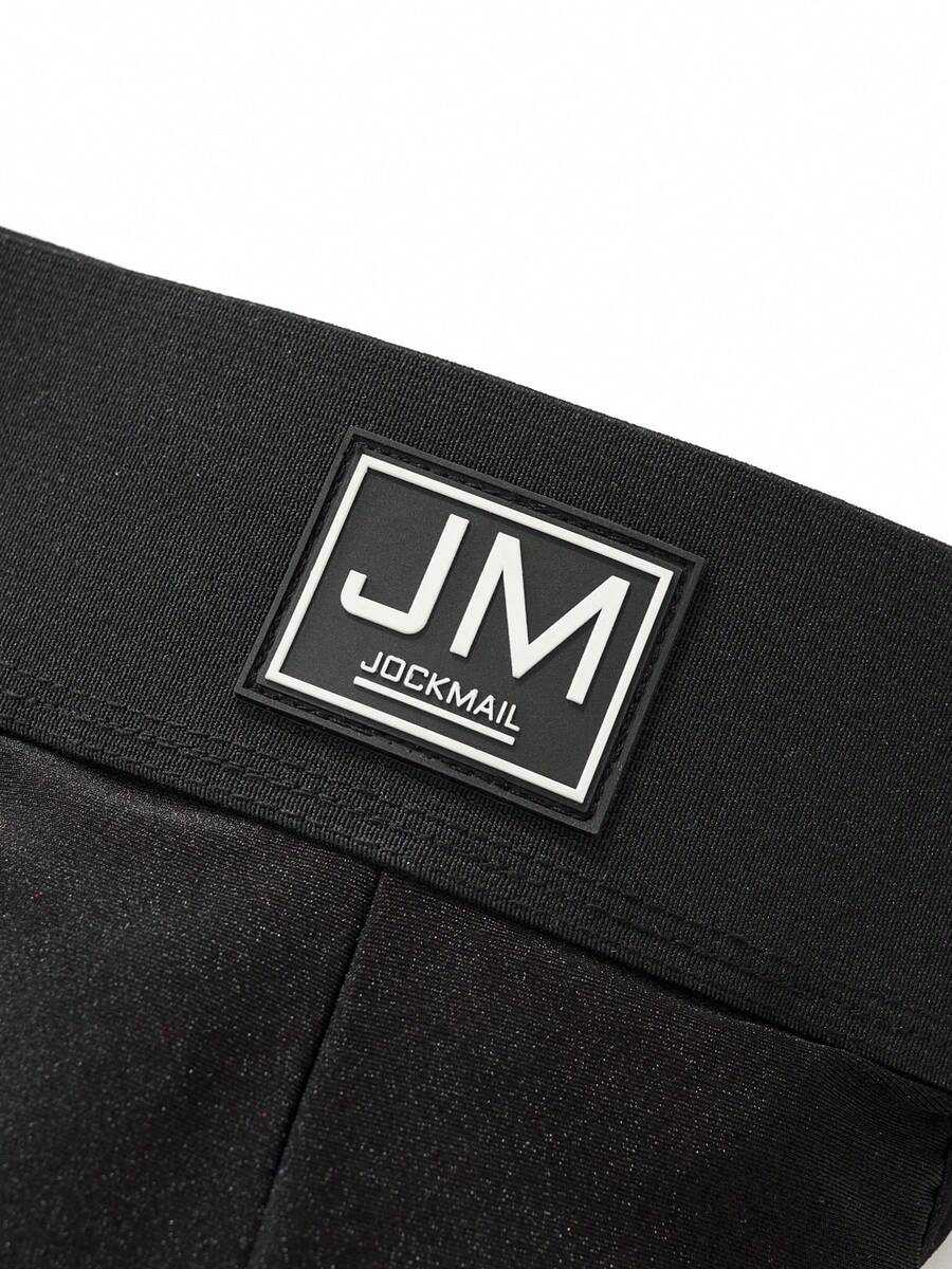 Black low rise men's jockstrap underwear featuring a letter print wide waistband
