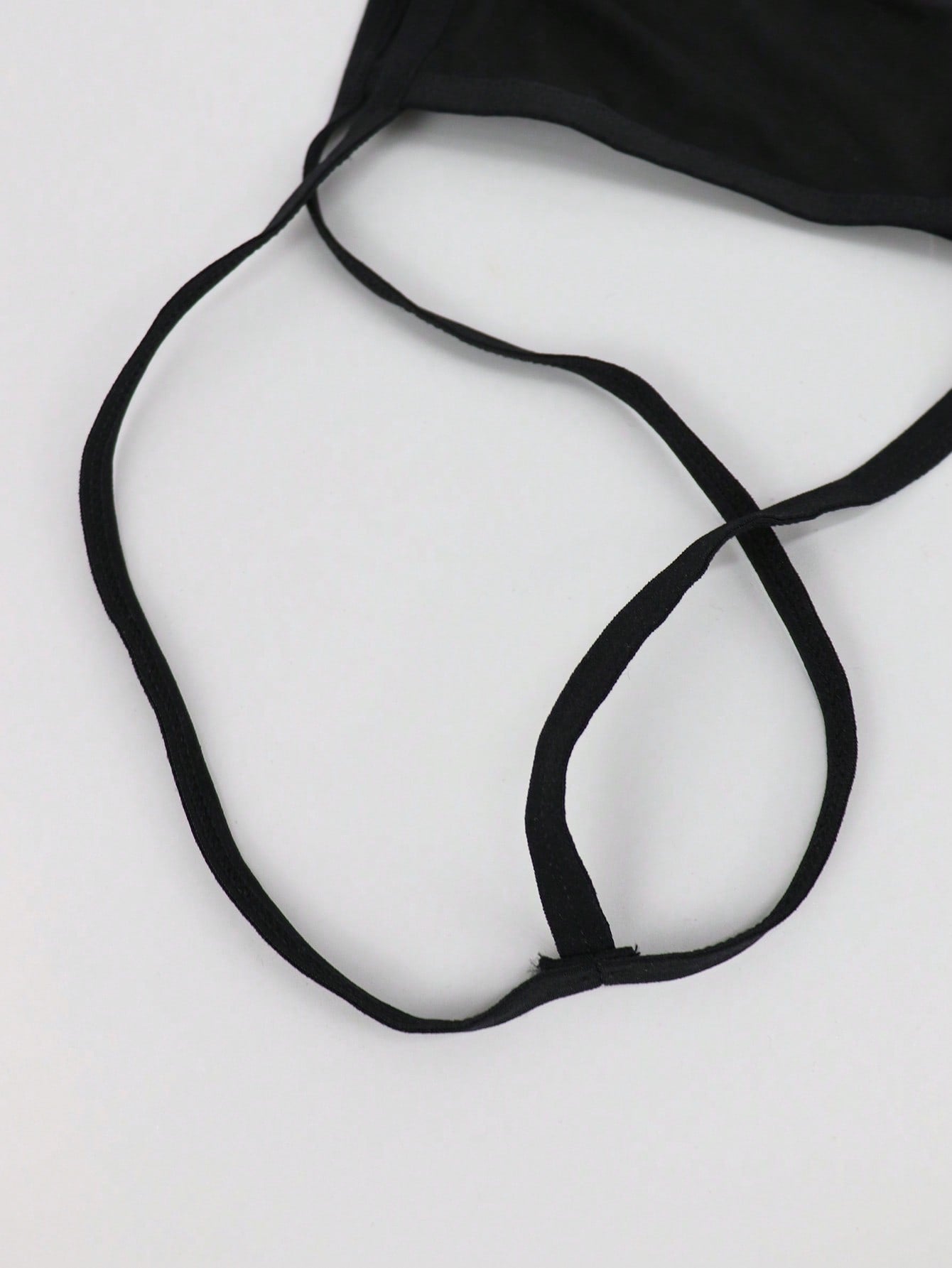 Black men's mesh thong underwear with a seamless low-rise design and medium-stretch fabric, one-piece style.