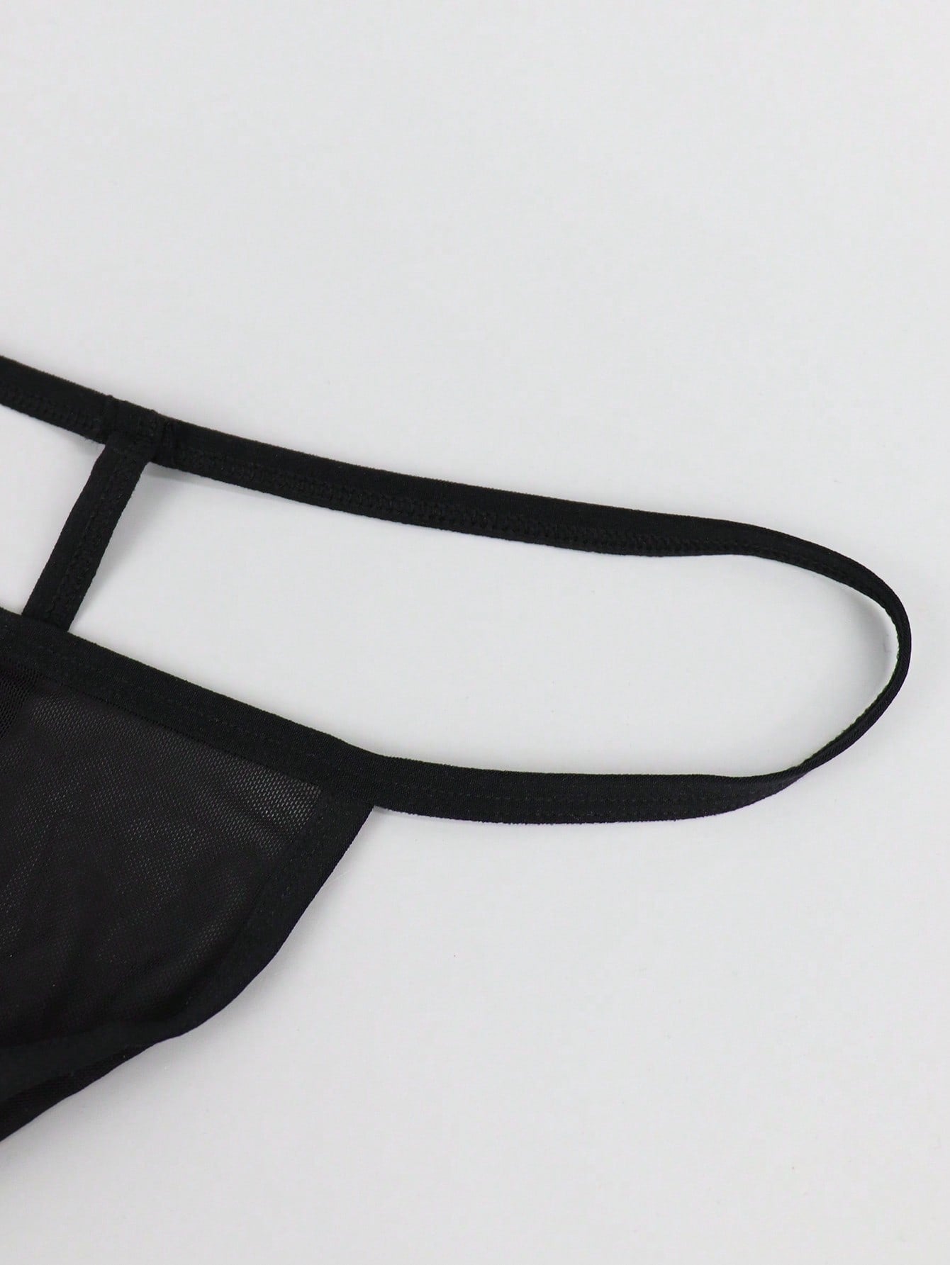 Black men's mesh thong underwear with a seamless low-rise design and medium-stretch fabric, one-piece style.