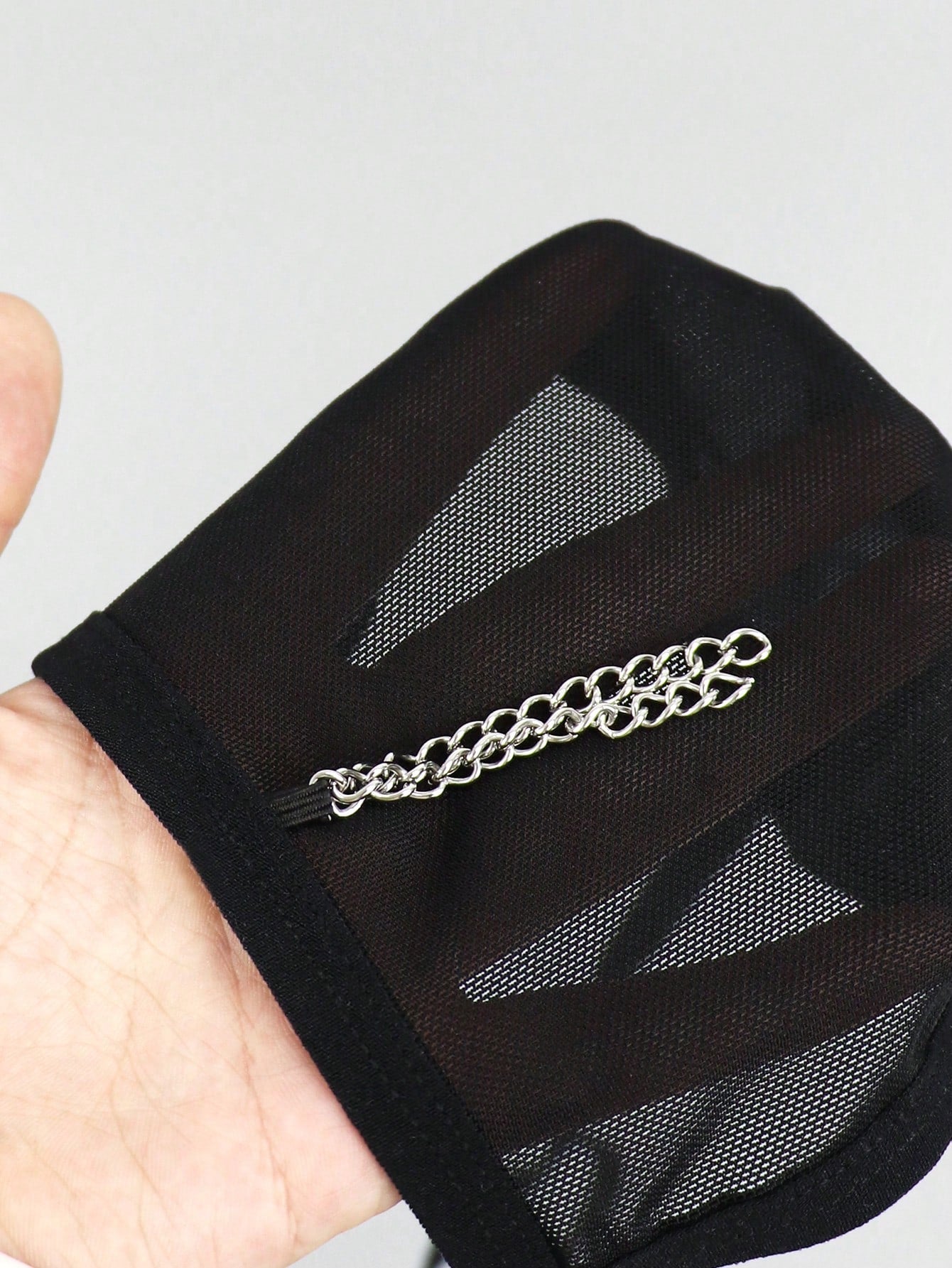 Black men's mesh thong underwear with a seamless low-rise design and medium-stretch fabric, one-piece style.