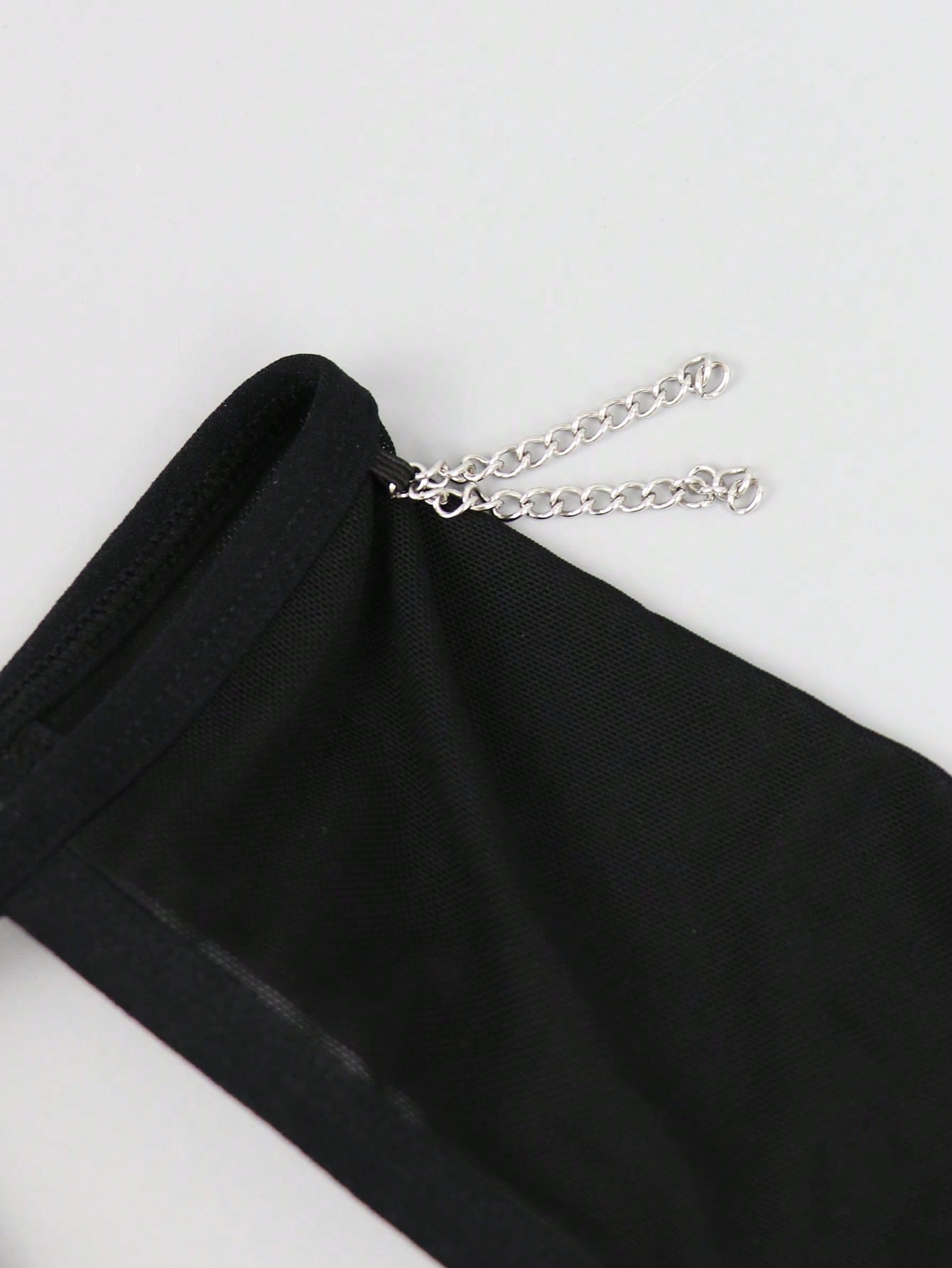Black men's mesh thong underwear with a seamless low-rise design and medium-stretch fabric, one-piece style.