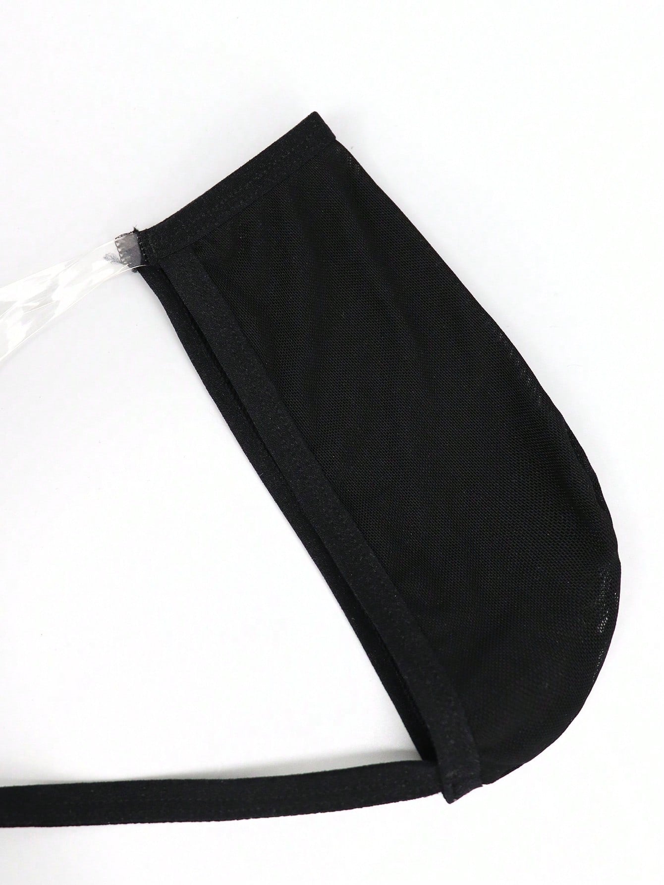 Black men's seamless mesh thong underwear with low-rise waist, colorblock design, and medium-stretch fabric.
