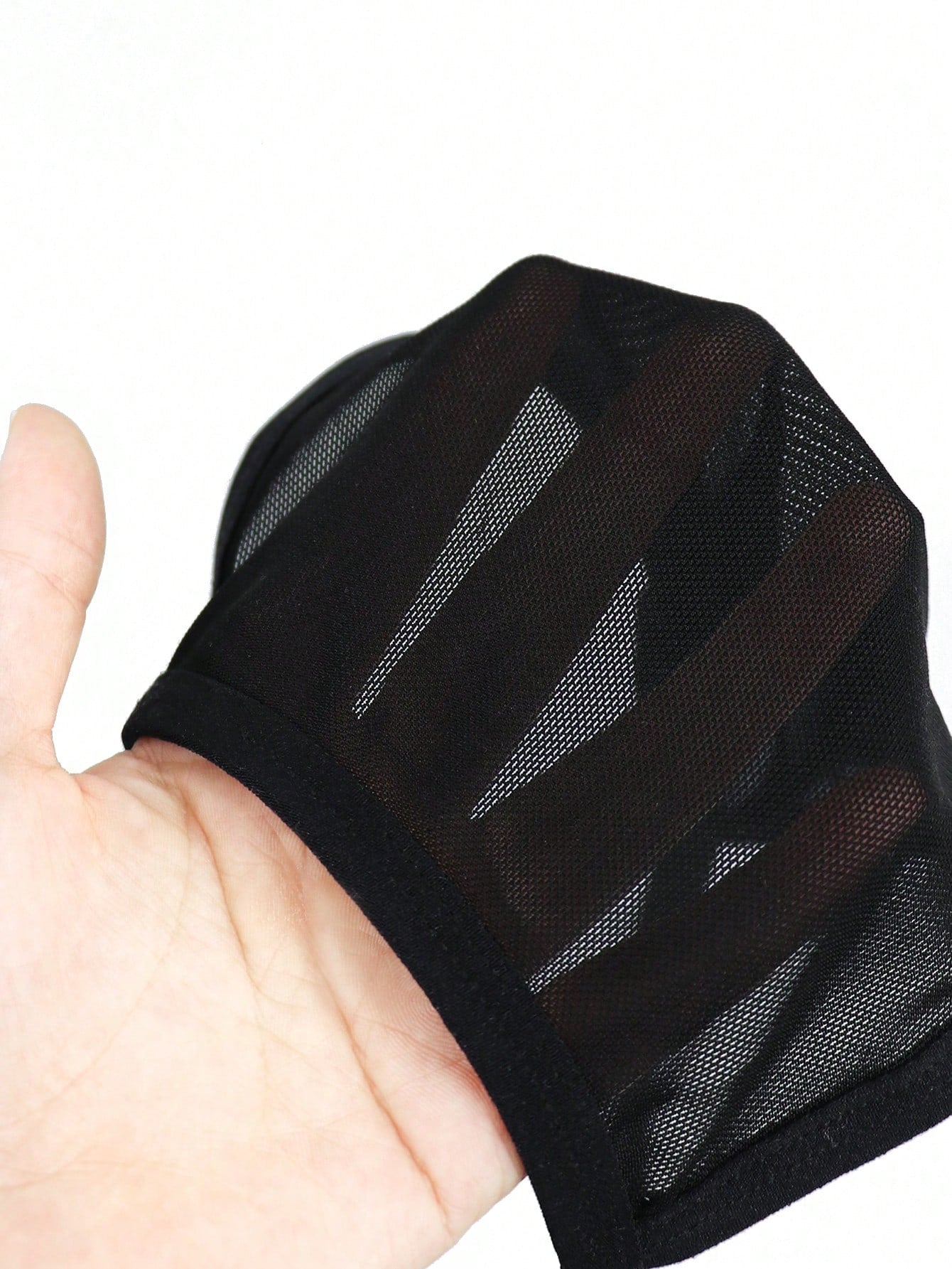 Black men's seamless mesh thong underwear with low-rise waist, colorblock design, and medium-stretch fabric.