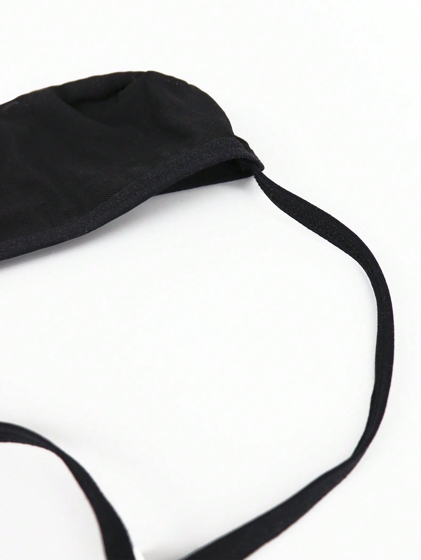 Black men's seamless mesh thong underwear with low-rise waist, colorblock design, and medium-stretch fabric.