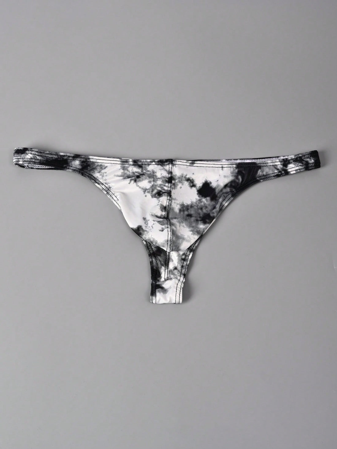 Men's tie dye thong underwear with a low rise fit and T-back design, made from polyester and elastane stretch fabric.