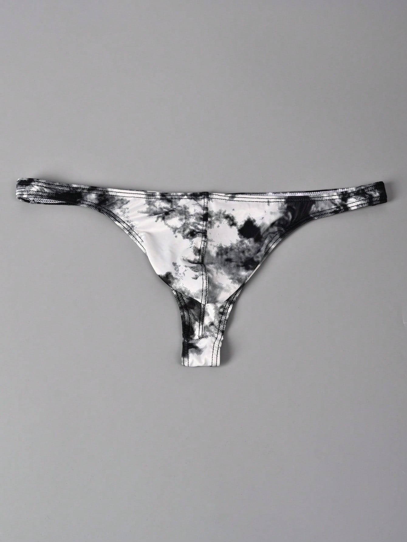 Men's tie dye thong underwear with a low rise fit and T-back design, made from polyester and elastane stretch fabric.