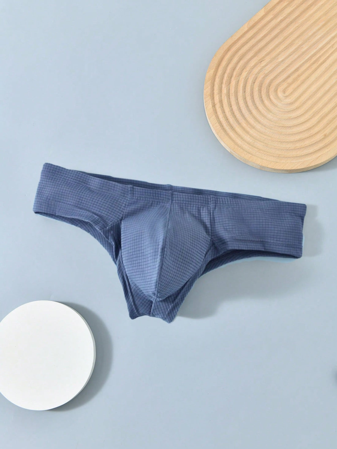 Men's low rise thong underwear in plain blue fabric with soft medium stretch and T-back design.