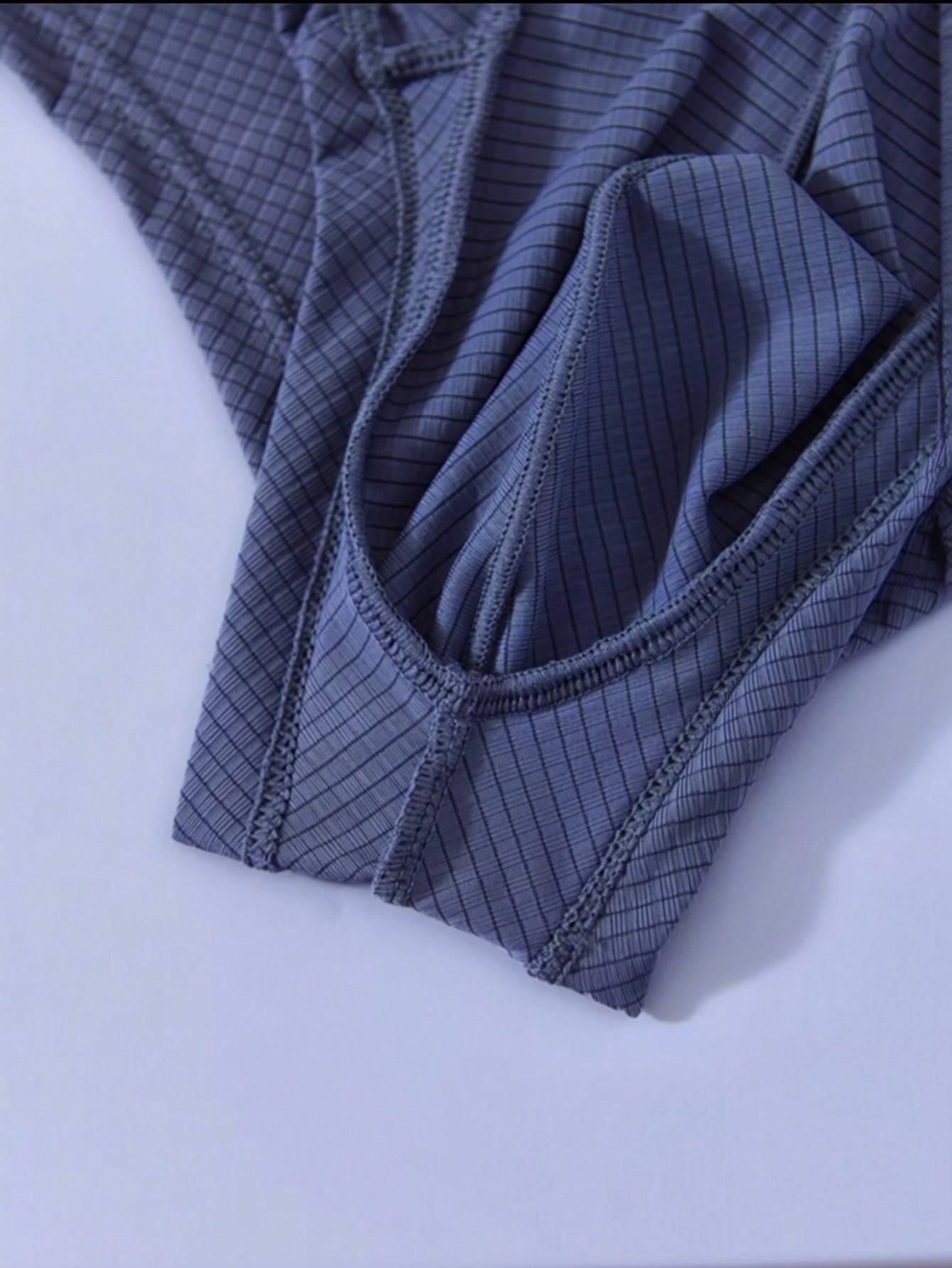 Men's low rise thong underwear in plain blue fabric with soft medium stretch and T-back design.
