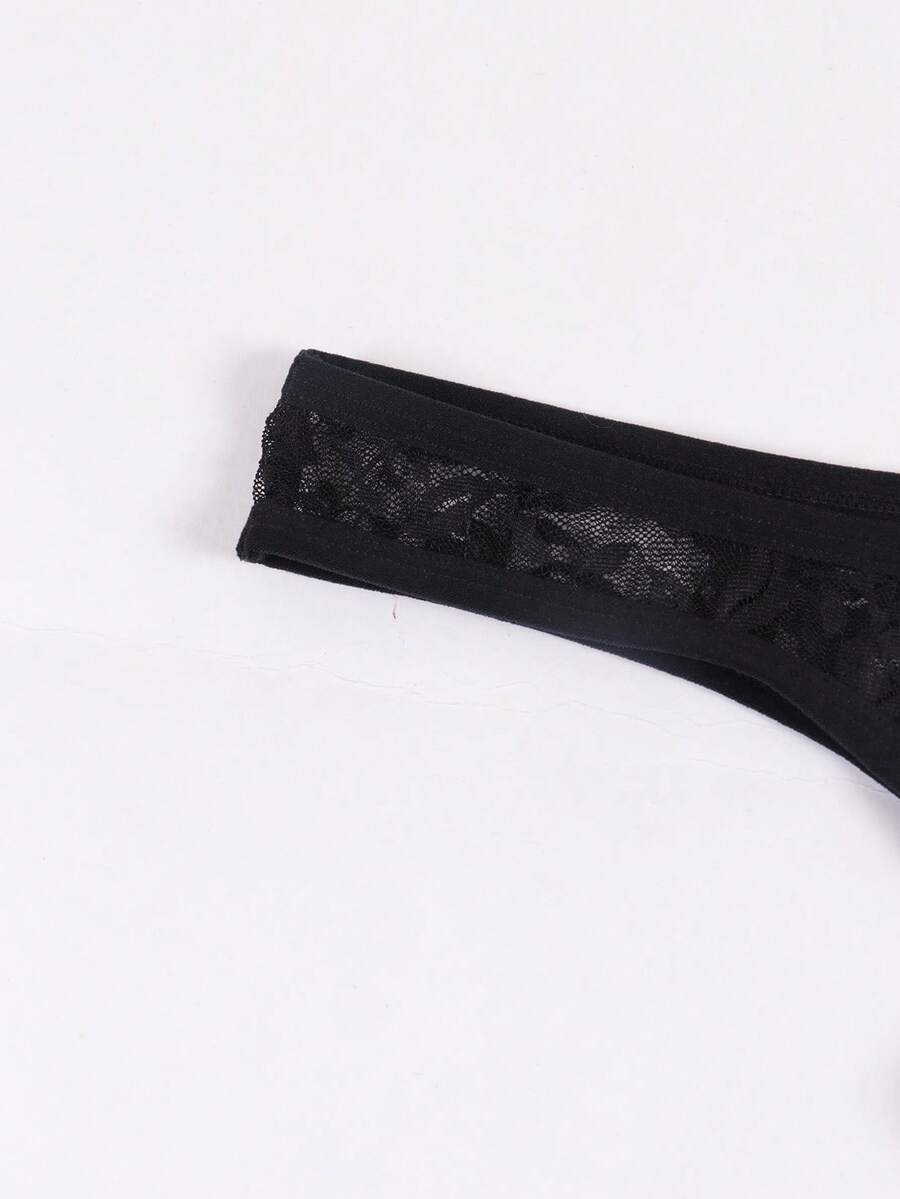 Men's black semi-sheer floral lace thong underwear featuring cut out design and low rise waistband.